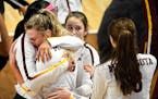 Minnesota setter Samantha Seliger-Swenson (13) was comforted by teammates as she hugged middle blocker Taylor Morgan following their 3-1 loss against 
