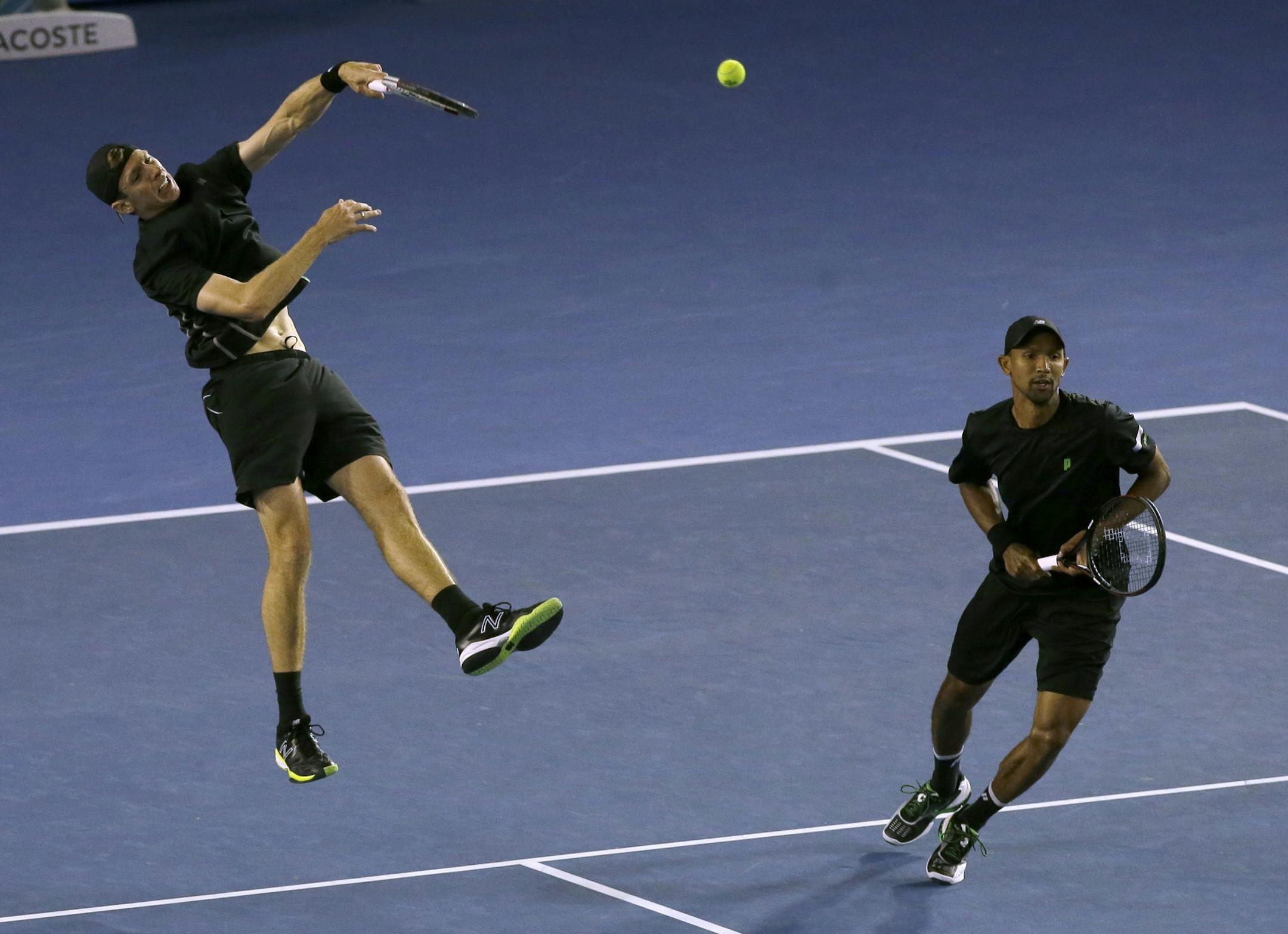 Eric Butorac of the U.S., left and Raven Klaasen of South Africa play in their men's doubles final against Lukasz Kubot of Poland and Robert Lindstedt of Sweden, at the Australian Open tennis championship in Melbourne, Australia, Saturday, Jan. 25, 2014.(AP Photo/Aijaz Rahi)