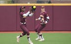 Gophers outfielder Amani Bradley (7) made a catch against Michigan, with Natalie DenHartog (31) nearby on Saturday Jane Sage Cowles Stadium.