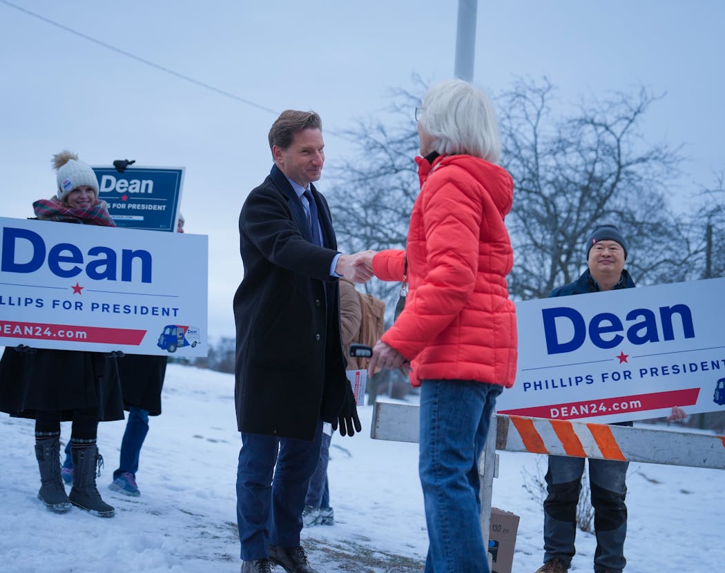 Dean Phillips spent the day of the primary election greeting voters and volunteers for other candidates outside polls in Manchester, N.H., on Tuesday.