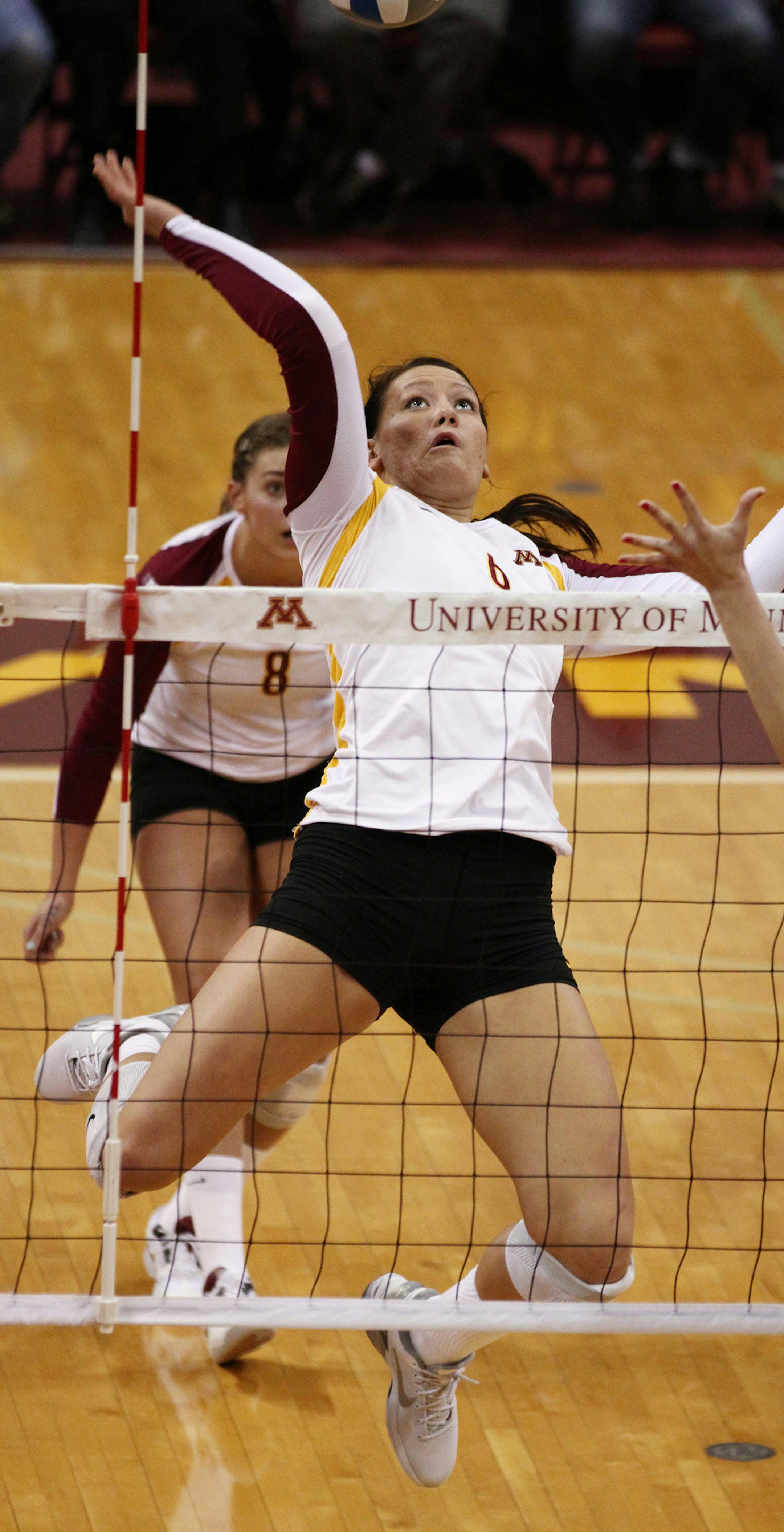 Minnesota's Tori Dixon spiked the ball over the net. ] MARISA WOJCIK - The University of Minnesota women's vollyball team played the Liberty Flames on Friday, November 30, 2012 at the Sports Pavilion in Minneapolis. ORG XMIT: MIN1211302059480248