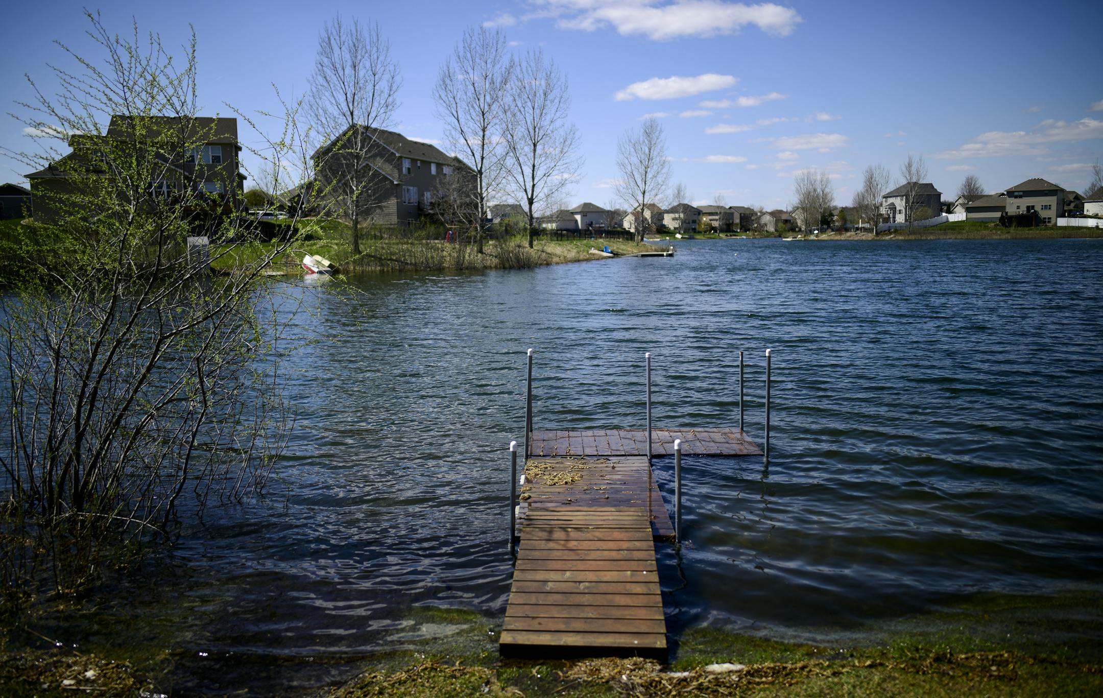 A homeowners dock sits on the water on Lake Ann Friday afternoon. ] Aaron Lavinsky ¥ aaron.lavinsky@startribune.com A hundred Farmington homeowners stand to lose their access to Lake Ann, a 25-acre stormwater pond that has become a favorite recreational spot, due to the city's recent acquisition of nine lots that residents use to enter the lake for swimming, kayaking and canoeing. The homeowners say they were promised lake access by the developer and many specifically chose to build homes n