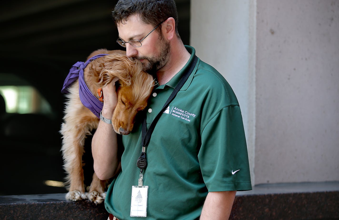 Tony Tengwall received comfort from Fitz during a trip outside during work, Wednesday, April 29, 2015 in Anoka, MN. Tengwall said that Ftiz will lay his head on his chest when he gets anxiety especially during a road rage situation, ] (ELIZABETH FLORES/STAR TRIBUNE) ELIZABETH FLORES &#x2022; eflores@startribune.com