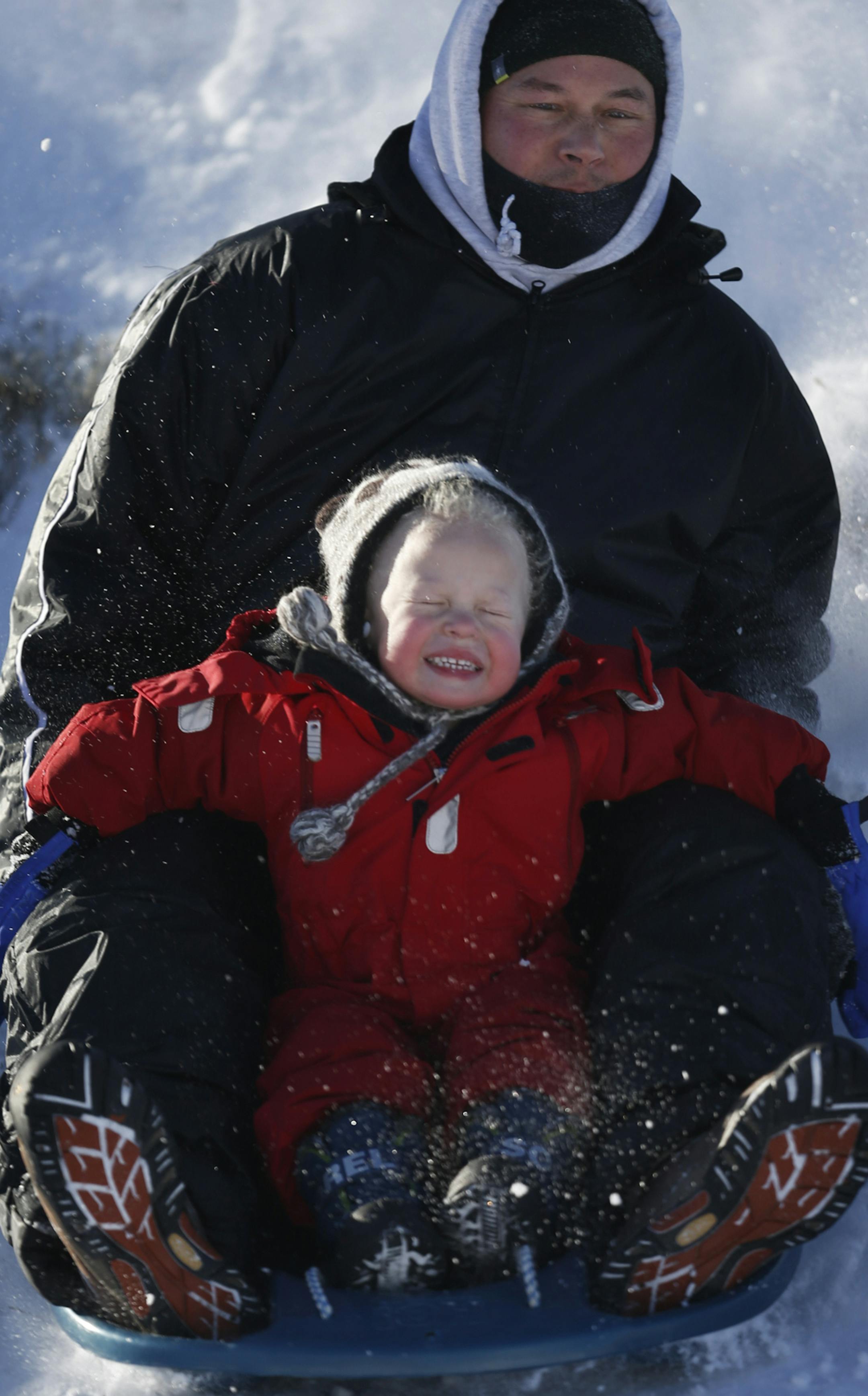 At Como Park, Ted Sheu and son Aksel,3, who live in the neighborhood braved the low single-digit temperatures and took to the hills to enjoy some sledding.]richard tsong-taatarii/rtsong-taatarii@startribune.com