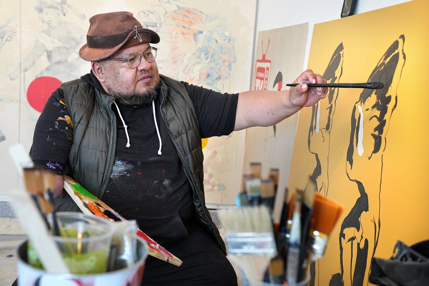 Artist Frank Buffalo Hyde works on a new painting in his garage studio at his Northfield home. Tuesday, March 14, 2023 in Northfield, Minn. On the new reality series "The Exhibit," Frank Buffalo Hyde knew he'd be representing, for better or worse, Indigenous artists. Turns out he's repping Minnesota, as well. The painter and sculptor is from Santa Fe. But during the pandemic, his ceramicist wife got a job at St. Olaf College. So now he's a Northfielder. Talking with Hyde about the new MTV series, in which six artists compete for an exhibition and a lot of cash. ] Brian Peterson • brian.peterson@startribune.com