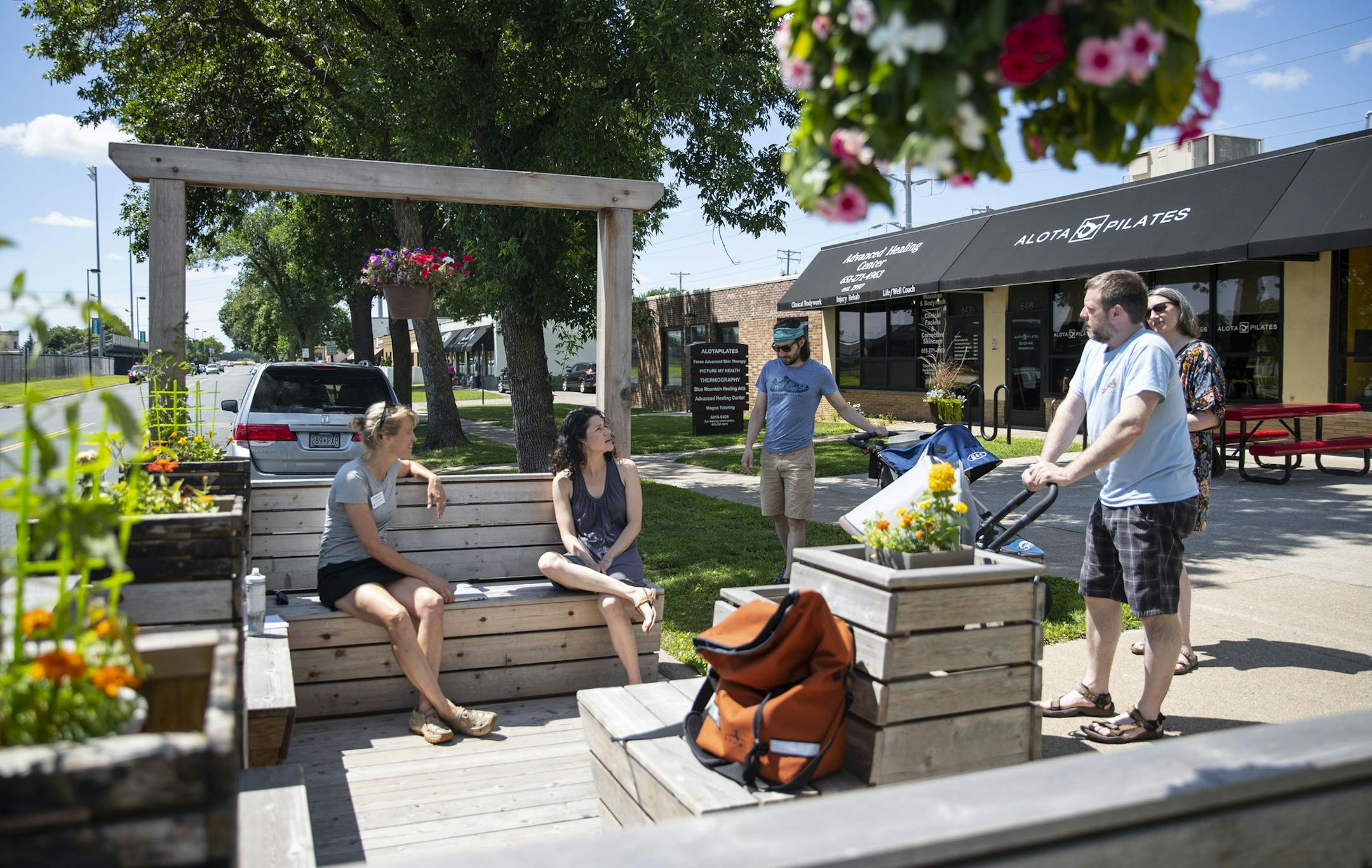 St. Louis Park City Council Member Margaret Rog (left) spoke with a group of local residents during her office hours being held in a parklet in St. Louis Park. ALEX KORMANN • alex.kormann@startribune.com St. Louis Park City Council Member Margaret Rog held open office hours in the parklet in St. Louis Park on Saturday Jul 27, 2019. A parklet is a small wooden space that is easily assembled and disassembled that encourages more pedestrian traffic and causes cars to slow down in the area it