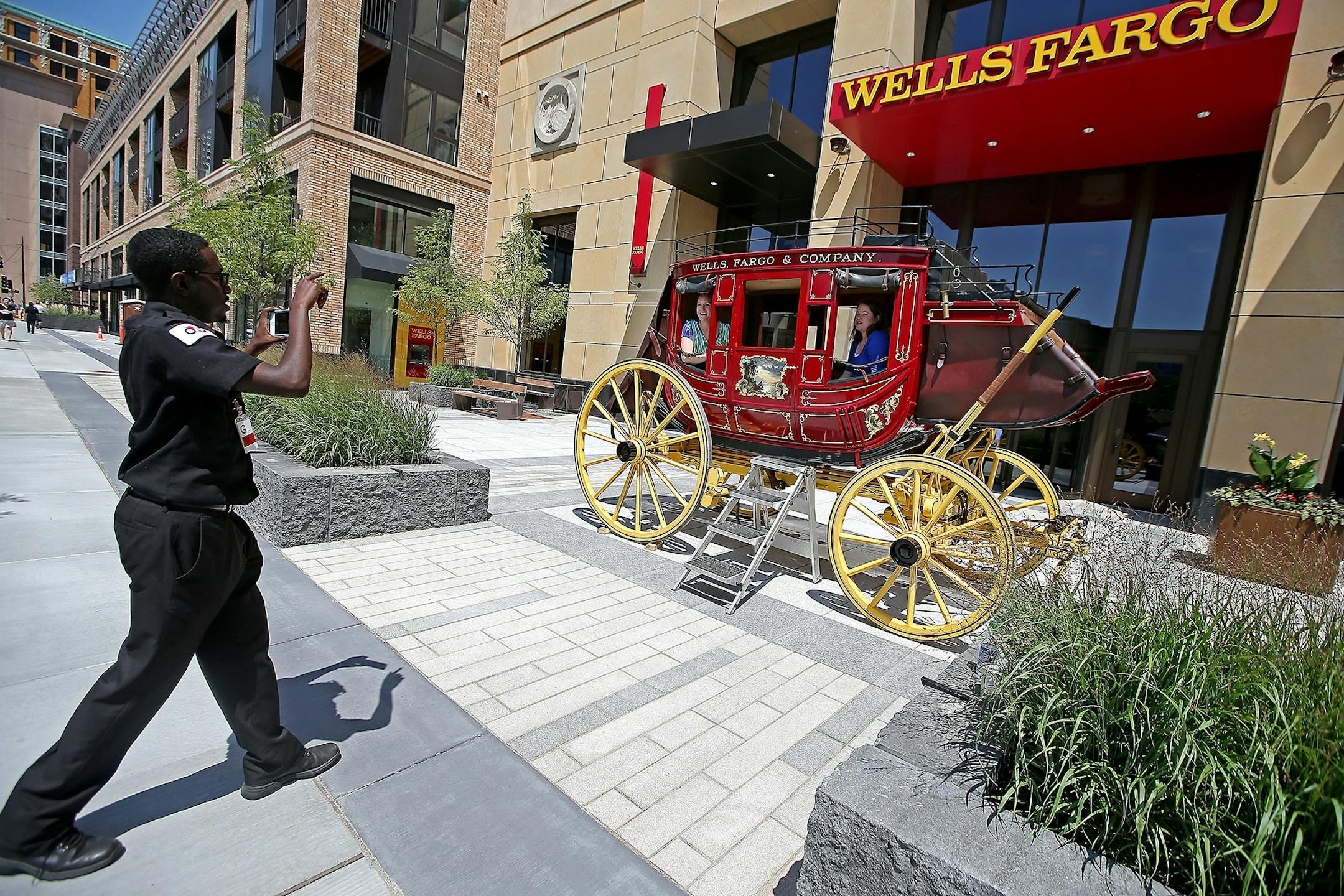 Wells Fargo employees and visitors visited and were photographed on the signature wagon as executives and city officials celebrated the grand opening of Minneapolis East Town Towers, Wednesday, July 20, 2016 in downtown Minneapolis, MN.