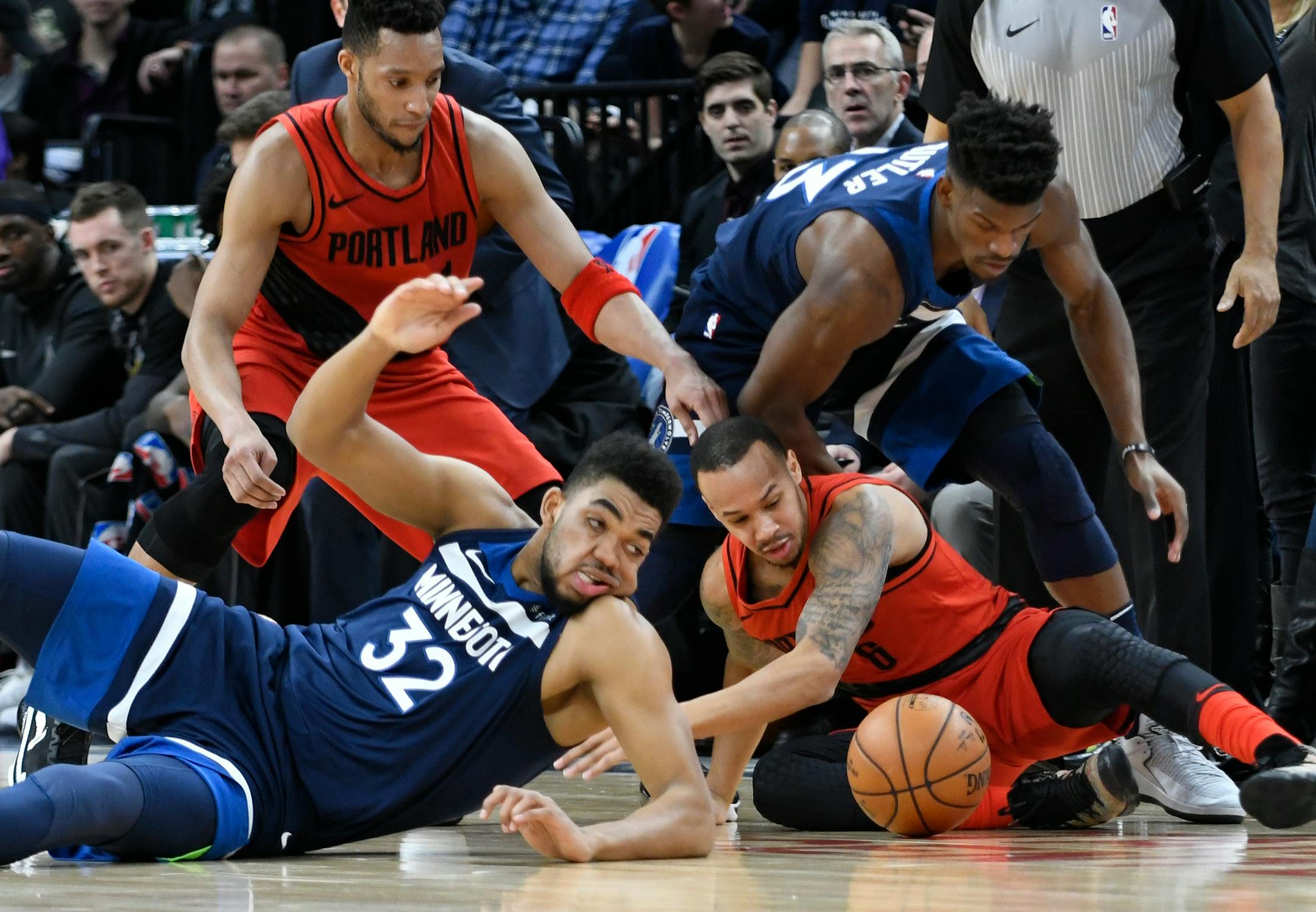 Karl-Anthony Towns, front left, and the Portland Trail Blazers' Damian Lillard, front right, go after the ball during the first half of an NBA basketball game Sunday, Jan. 14, 2018, in Minneapolis.