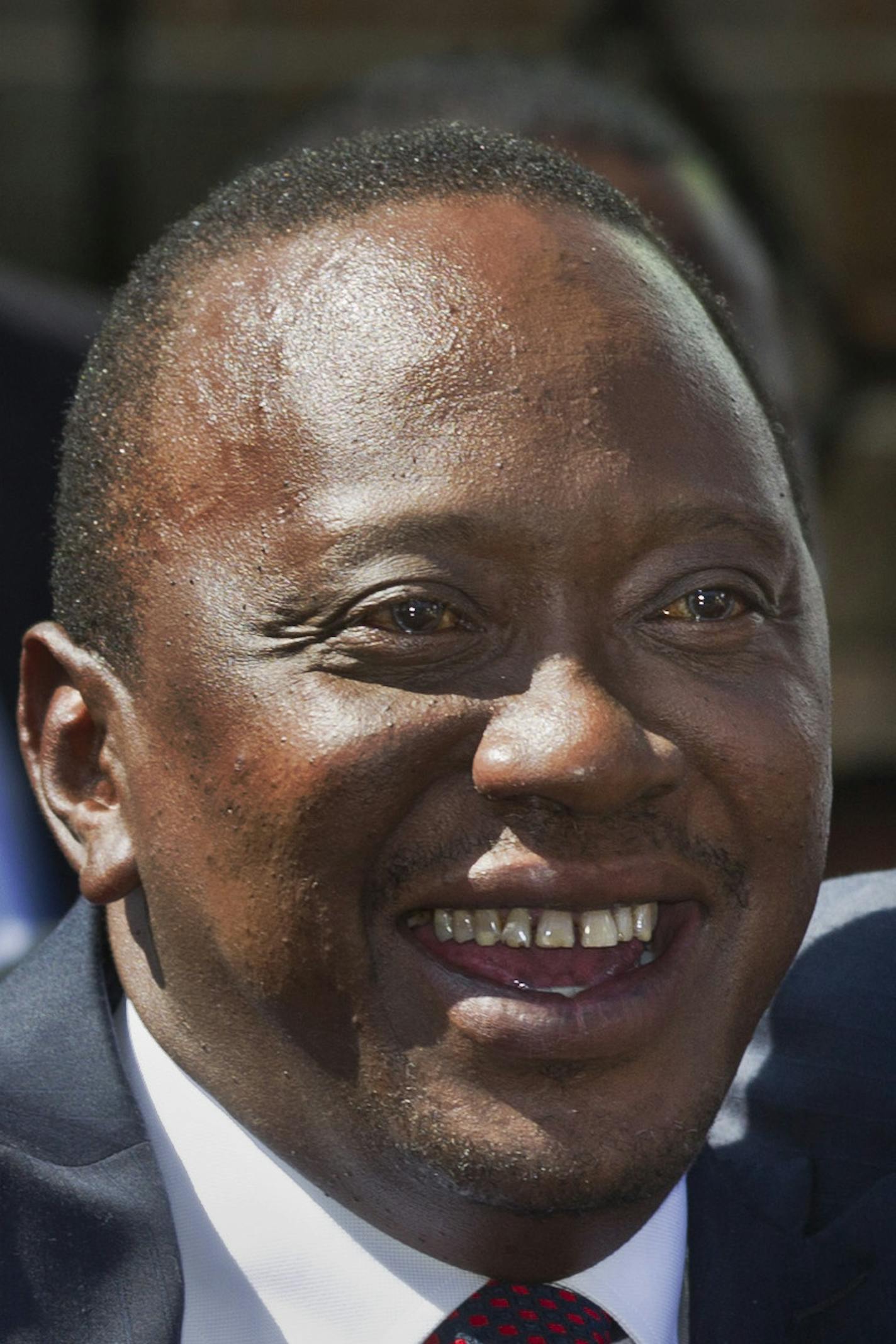 FILE - In this Saturday, March 2, 2013 file photo, Kenya's then President-Elect Uhuru Kenyatta waves to supporters after leaving the National Election Center where final election results were announced declaring he would be the country's next president, in Nairobi, Kenya Saturday, March 9, 2013. The International Criminal Court's chief prosecutor dropped all crimes against humanity charges against Kenya's president Uhuru Kenyatta on Friday, Dec. 5, 2014 highlighting the court's problems in bring