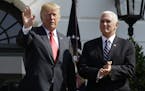 President Donald Trump, standing with Vice President Mike Pence, right, waves after delivering remarks on the economy at the White House, Friday, July