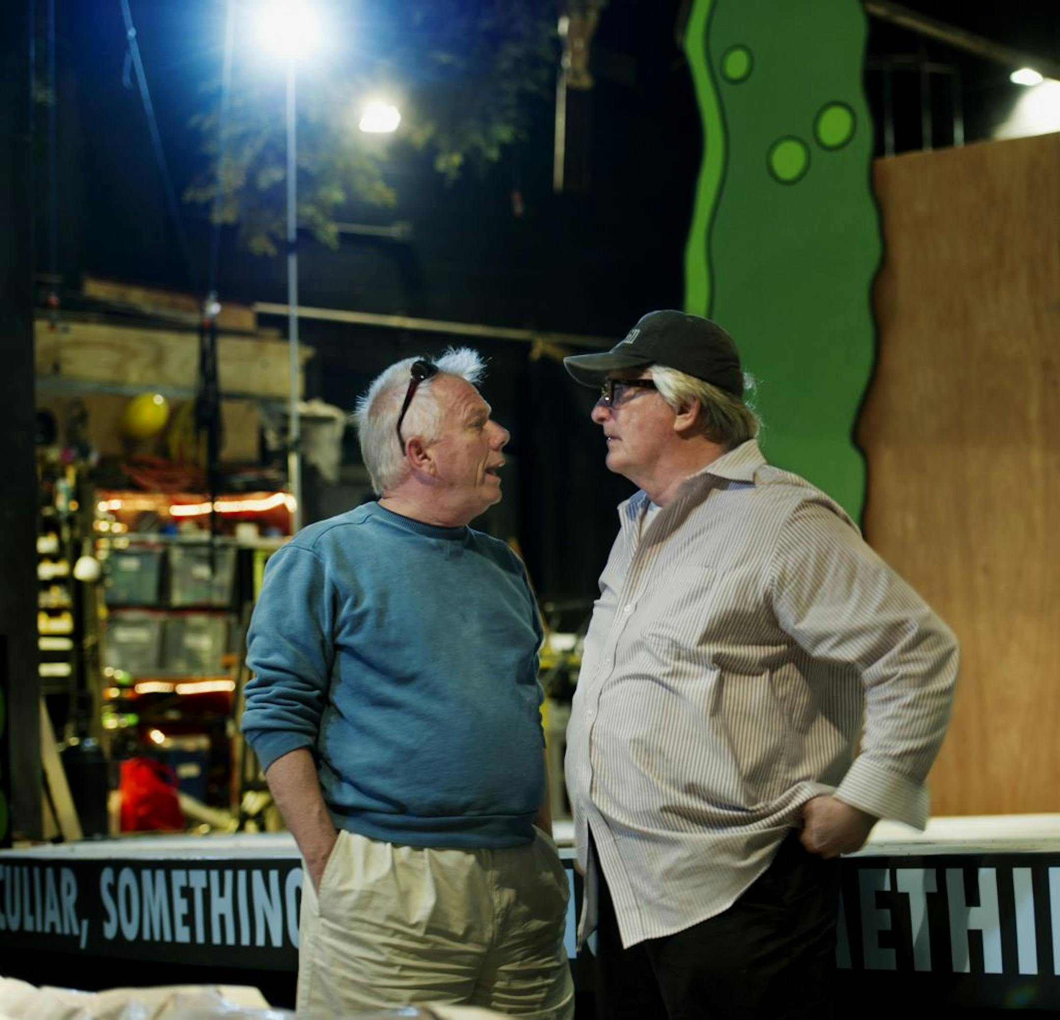 John Command and Bain Boehlke, with staging under construction in background, talked about the upcoming Jungle Theater production "A Funny Thing Happened on the Way to the Forum."