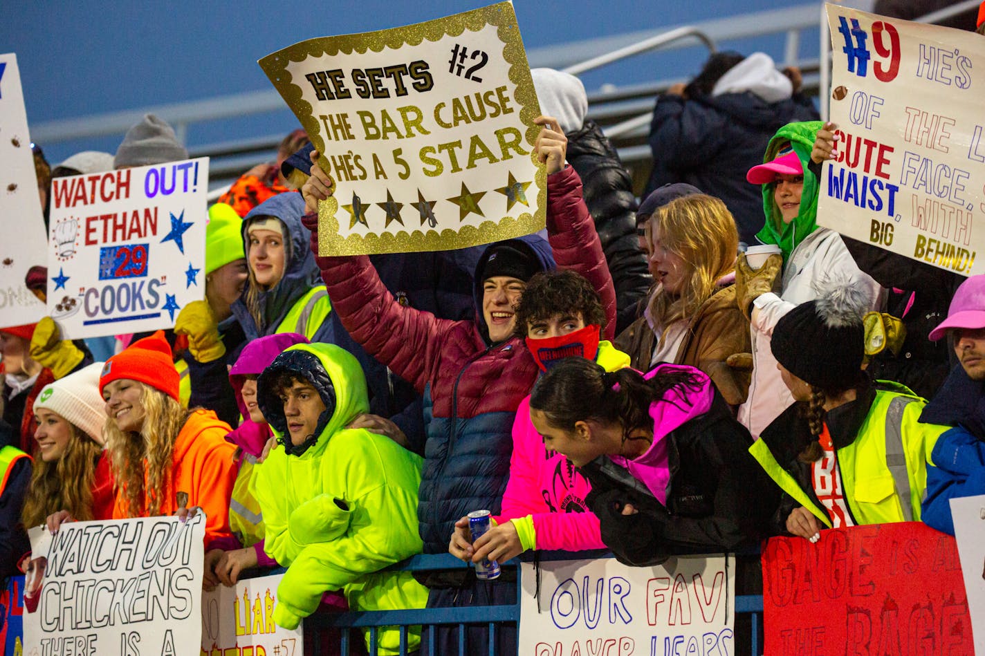 Students cheer and hold up signs before an Orono game against Totino-Grace at Orono High School Friday, Oct. 13, 2023.