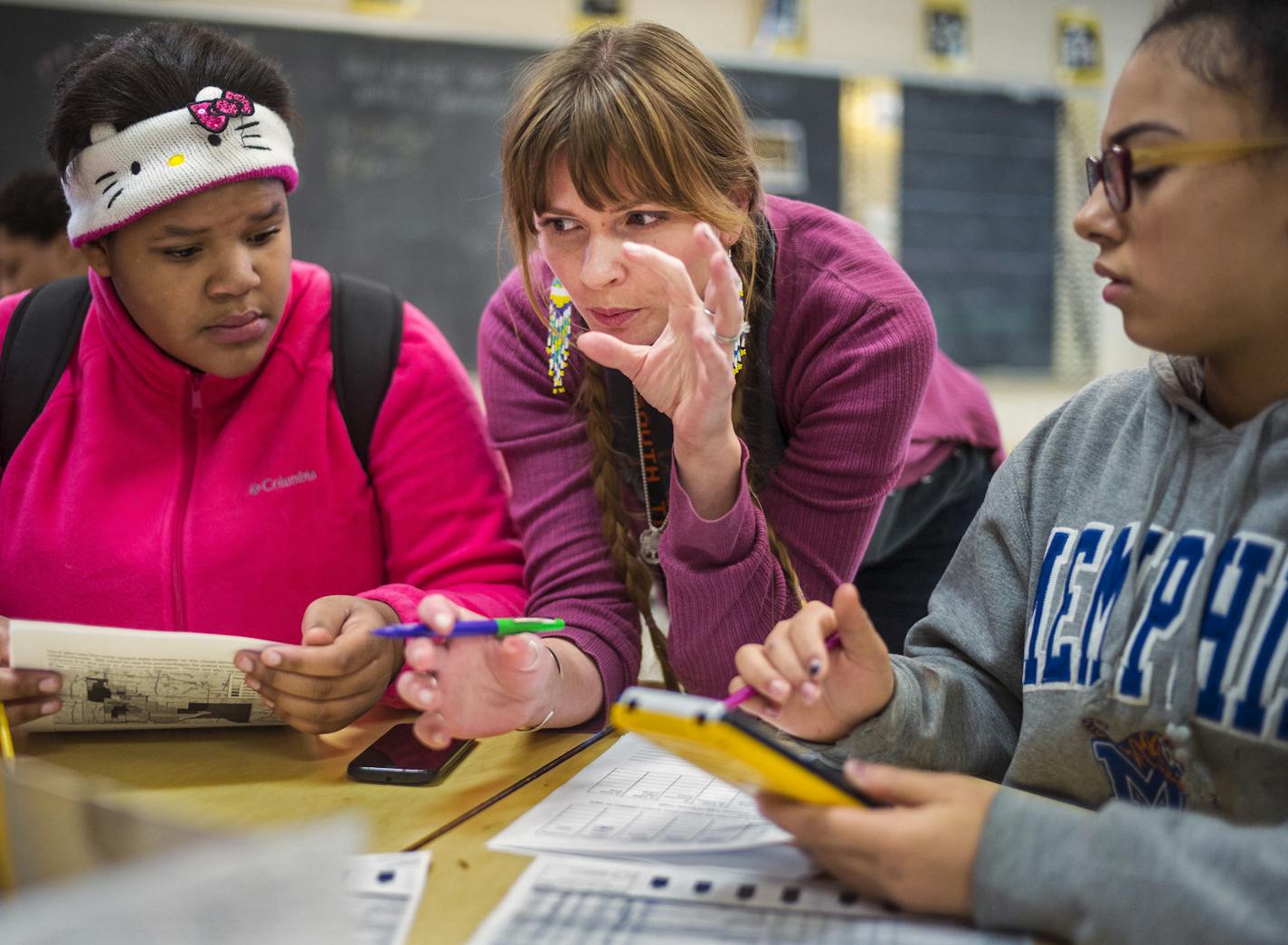 At South H.S., algebra teacher Stephanie Woldrum uses social justice as a way to illustrate how math can solve problems in the world. Today, she and students Syncere(cq)l Davis,15,left and Sisi Mitchell, 14 are looking at statistics on police/public transactions in the different precincts .]Richard Tsong-Taatarii/rtsong-taatarii@startribune.com