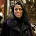 In this Dec. 13, 2016 photo, Omarosa Manigault smiles at reporters as she walks through the lobby of Trump Tower in New York.