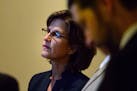 State Auditor Rebecca Otto watched the House proceedings in the hallway outside the chambers as her office was impacted by a surprise piece of legisla