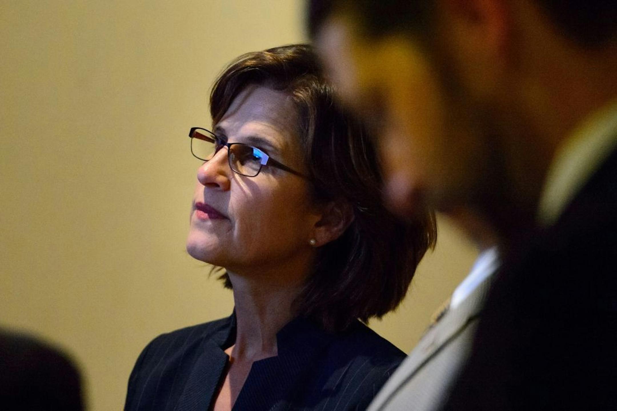 State Auditor Rebecca Otto watched the House proceedings in the hallway outside the chambers as her office was impacted by a surprise piece of legislation on the final day of the session.