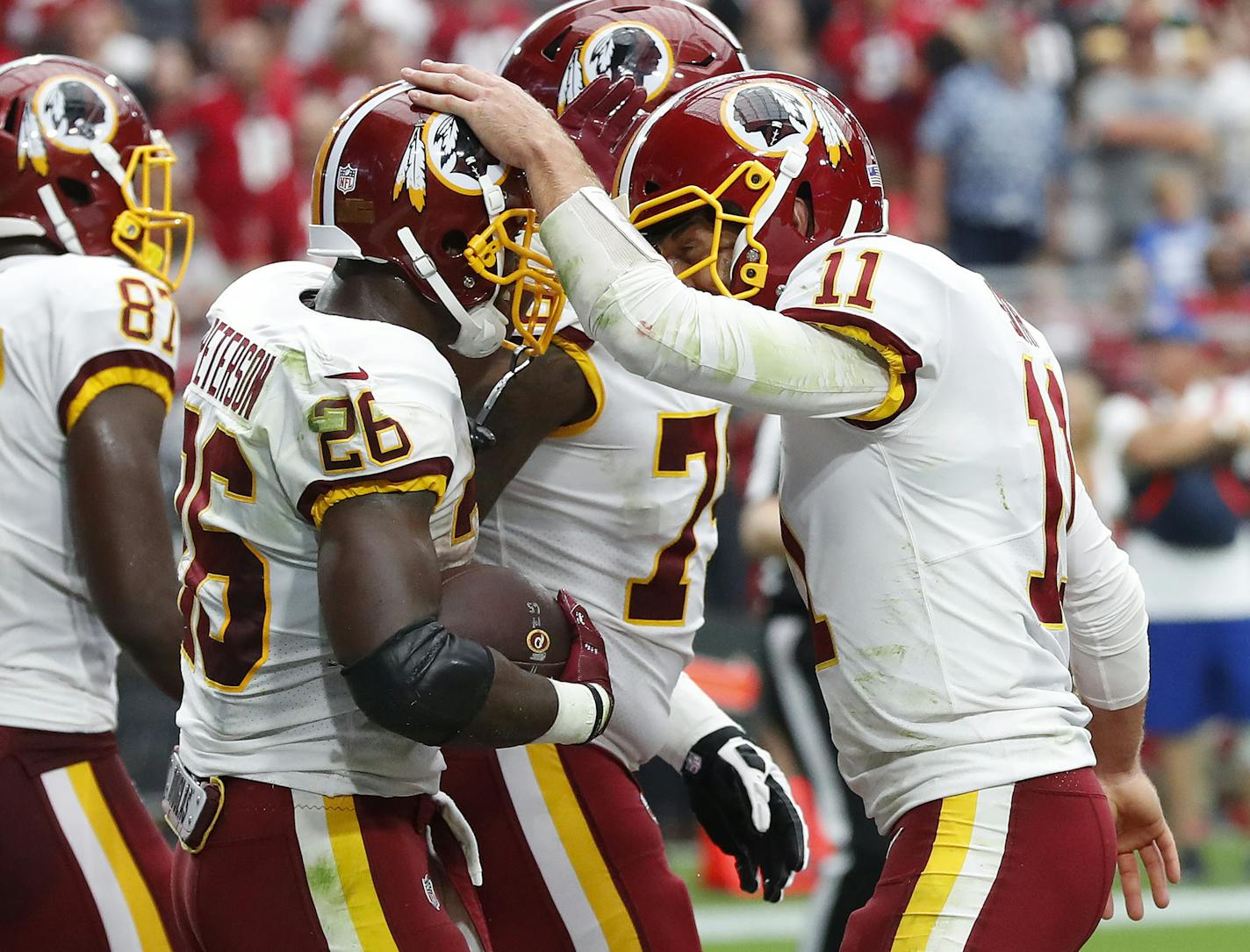 Washington Redskins running back Adrian Peterson (26) celebrates his touchdown run with quarterback Alex Smith (11) during the first half of an NFL football game against the Arizona Cardinals, Sunday, Sept. 9, 2018, in Glendale, Ariz. (AP Photo/Rick Scuteri) ORG XMIT: AZMY