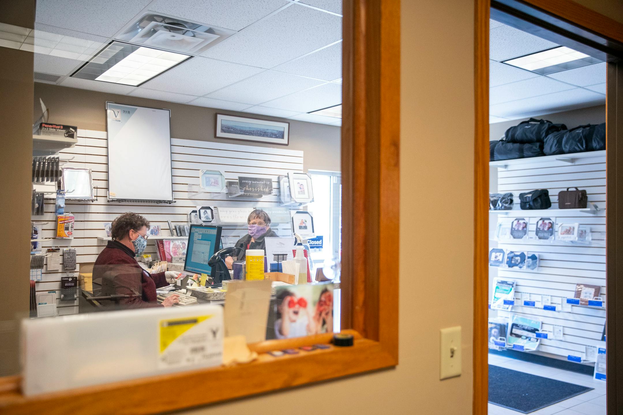 Cathy Mennes, co-owner of First Photo, assisted a customer on Wednesday, March 31, 2021.