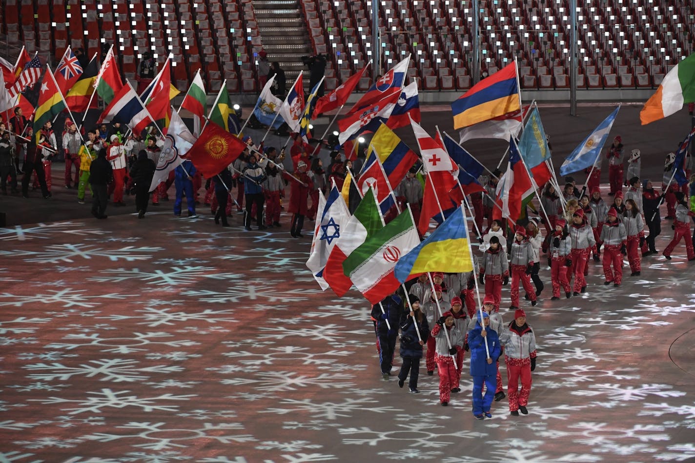 Athletes carry flags of participating countries during the closing ceremony of the 2018 Winter Olympics in Pyeongchang, South Korea, Feb. 25, 2018.