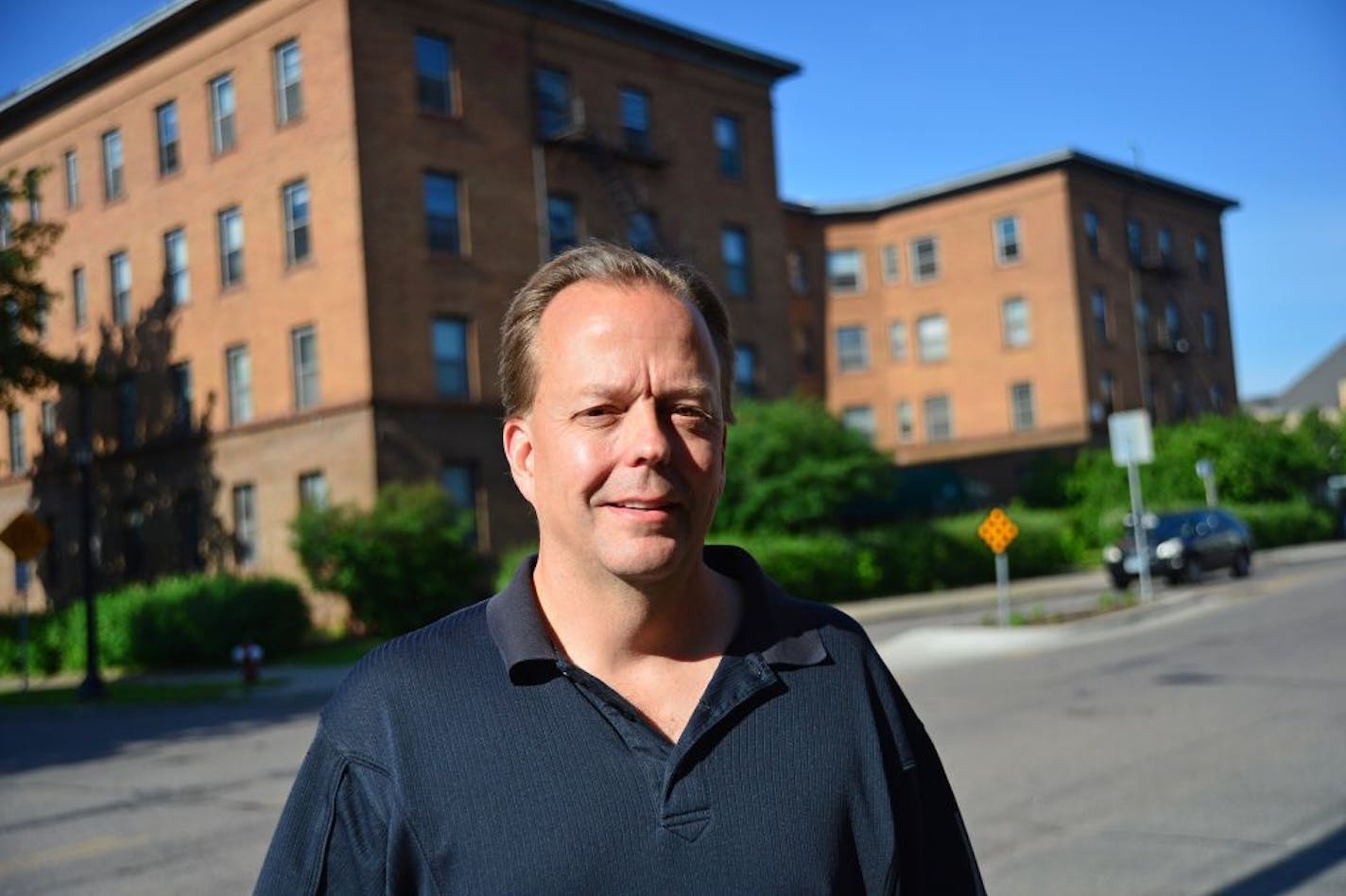 Steve Frenz, shown with an apartment building on Franklin Avenue in south Minneapolis. Thousands of tenants could be affected if the city strips Frenz of the rental licenses.