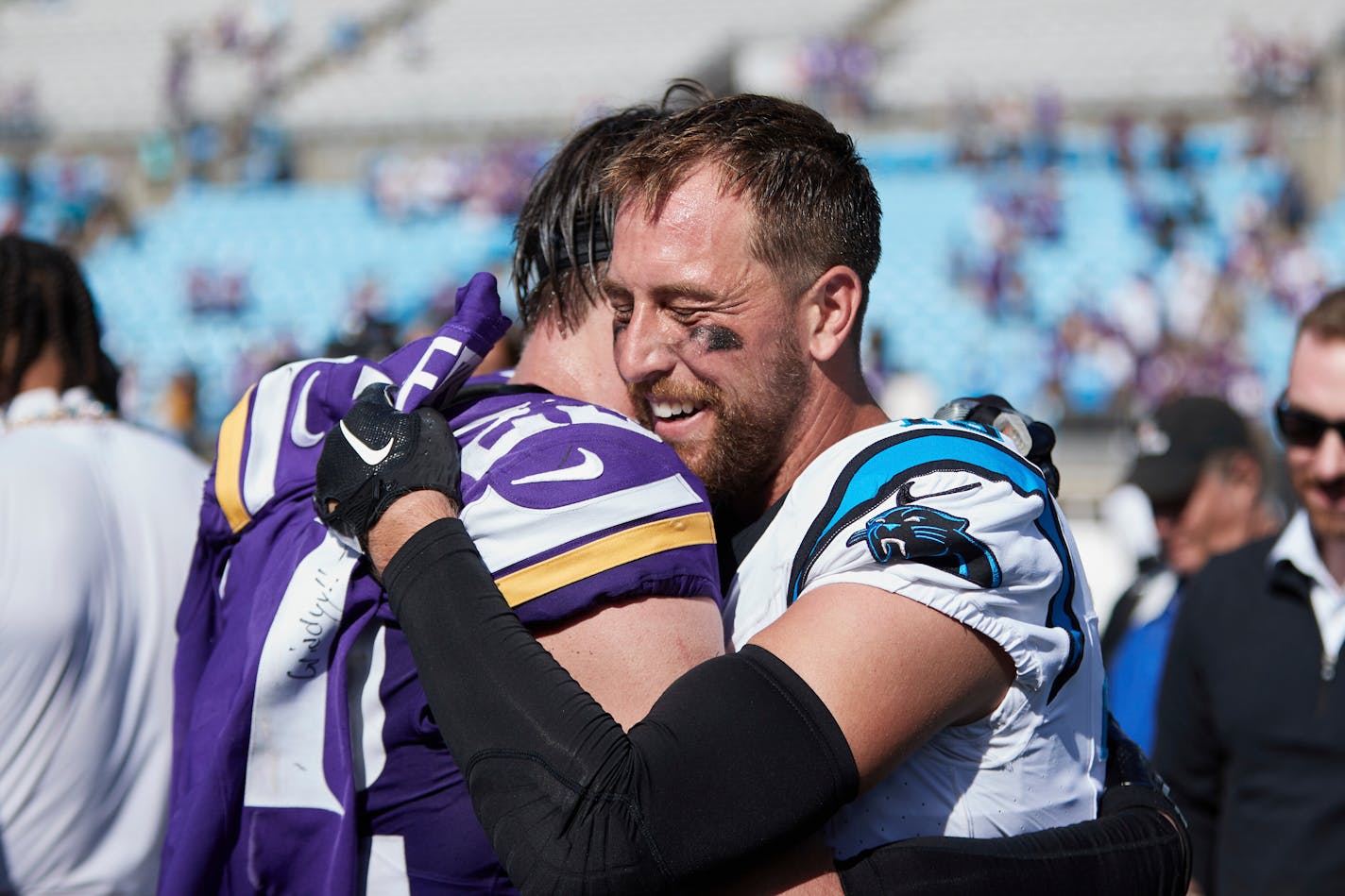 Carolina Panthers wide receiver Adam Thielen (19) hugs former teammate Minnesota Vikings safety Harrison Smith (22) following an NFL football game, Sunday, Oct. 1, 2023, in Charlotte, N.C. (AP Photo/Brian Westerholt)