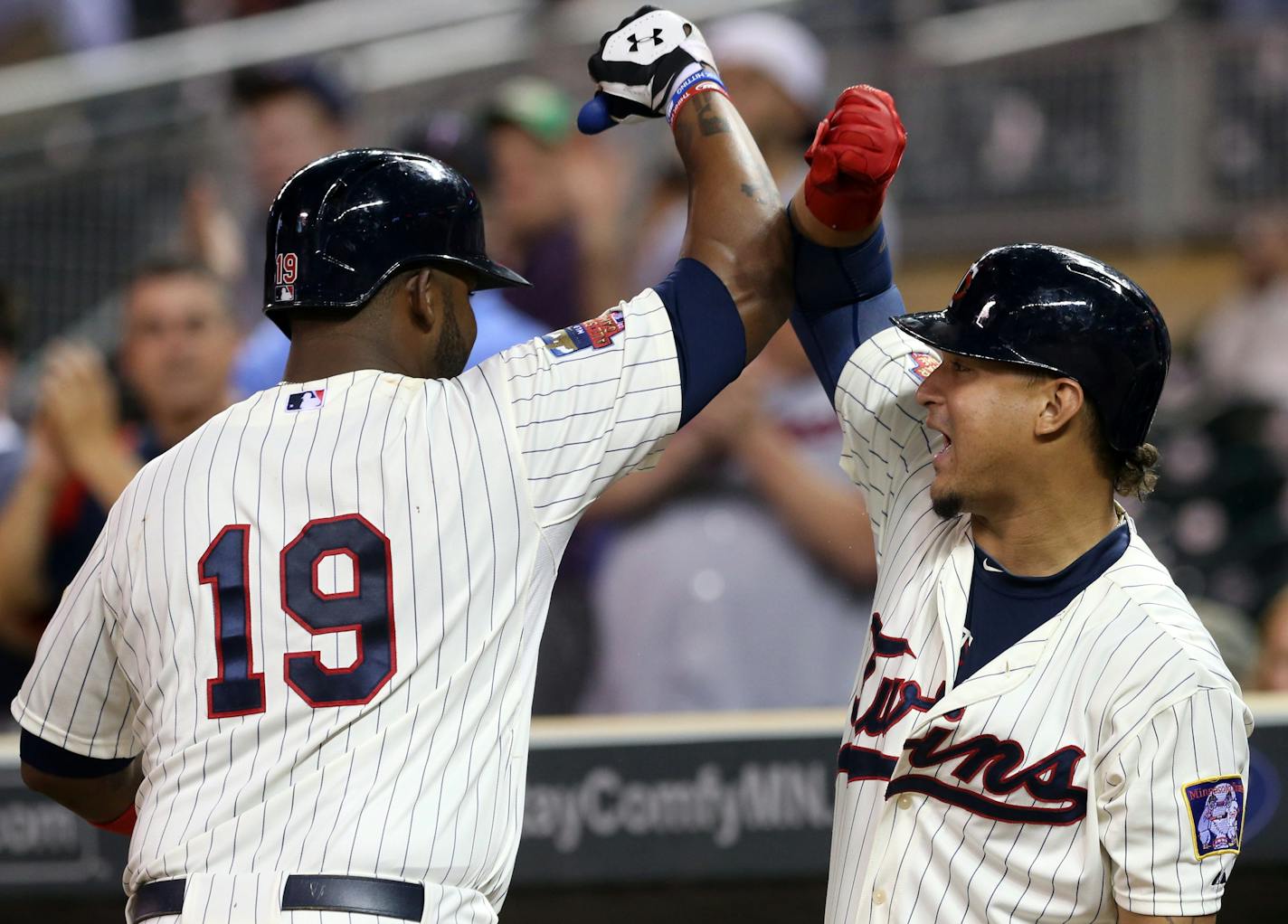 Minnesota Twins' Kennys Vargas, left, is congratulated by teammate Oswaldo Arcia following his two-run home run off Chicago White Sox pitcher Scott Snodgress in the sixth inning of a baseball game, Wednesday, Sept. 3, 2014, in Minneapolis. (AP Photo/Jim Mone)