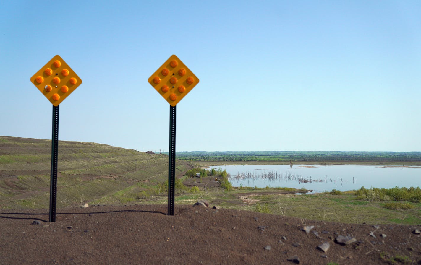 The Polymet tailings ponds could be seen over a small berm. ] ANTHONY SOUFFLE &#x2022; anthony.souffle@startribune.com Jon Cherry, President, CEO and Director at Polymet, Bruce Richardson, Vice President of Corporate Communications and External Affairs, and LaTisha Gietzen, Vice-President of Public, Government, and Environmental Affairs, gave a tour of the site of the Polymet copper-nickel mine to discuss what's next now that the controversial project has it's major environmental permits Wednesd