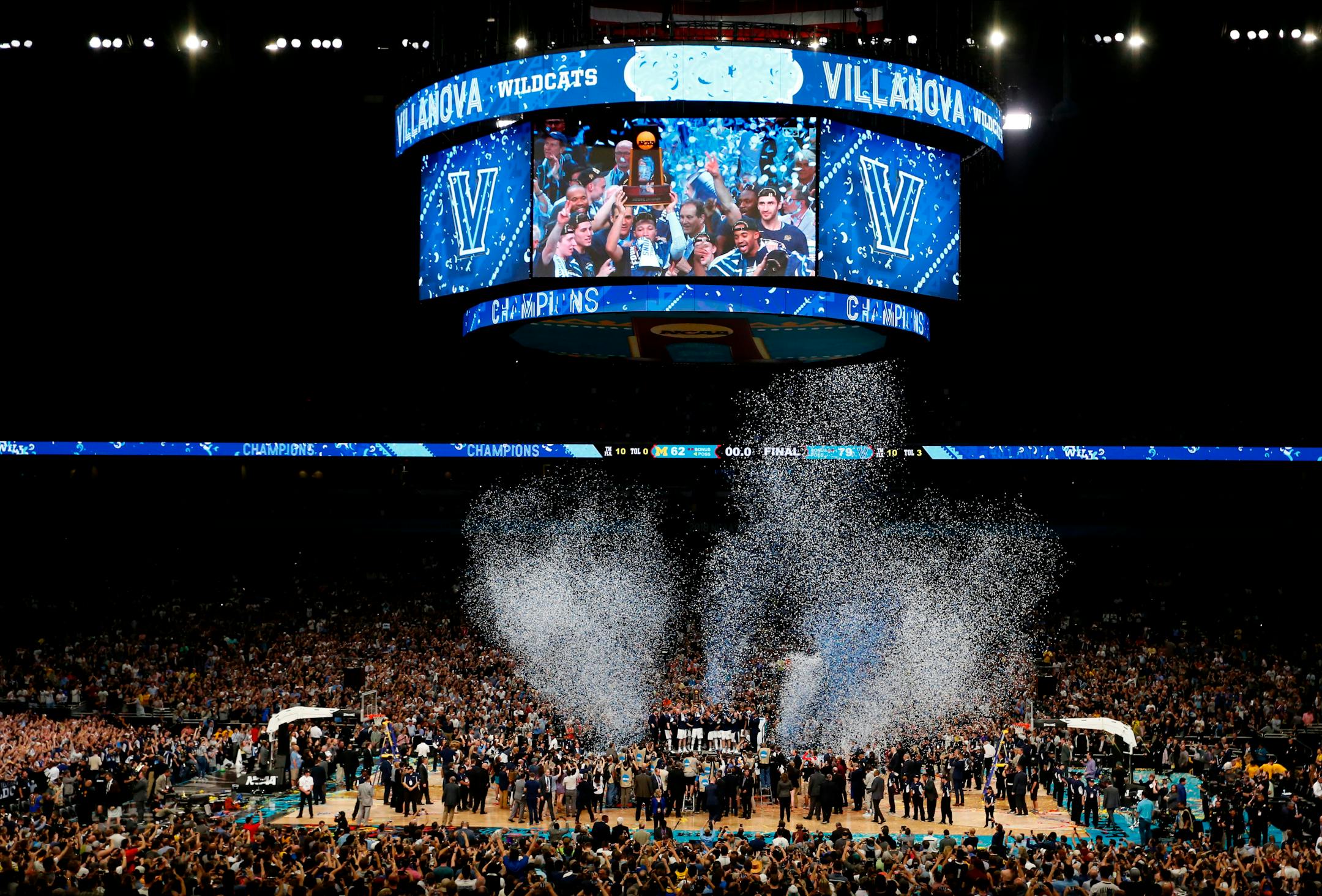 Villanova players celebrate on the court after beating Michigan 79-62