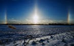 DAVID BREWSTER â€¢ dbrewster@startribune.com Sat. 01/01/11 Mankato : ] Sun dogs bracketed the setting sun over snow covered farm fields north of M
