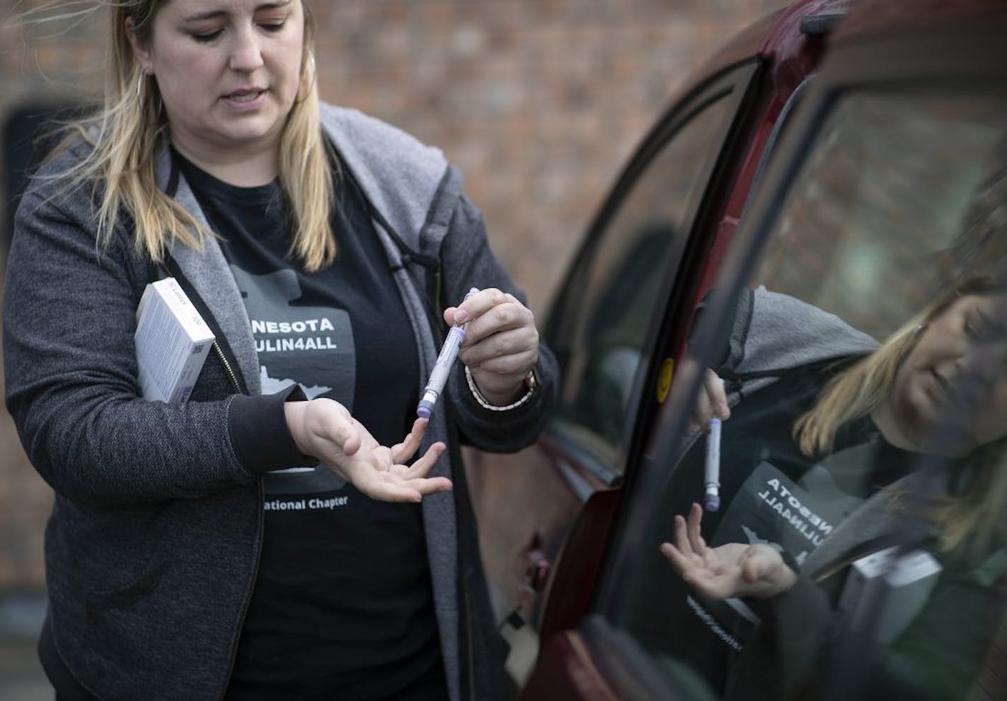 Activist Quinn Nystrom of Baxter looked over an insulin pen the she purchased Saturday May 4, 2019, in Fort Frances, Ontario.