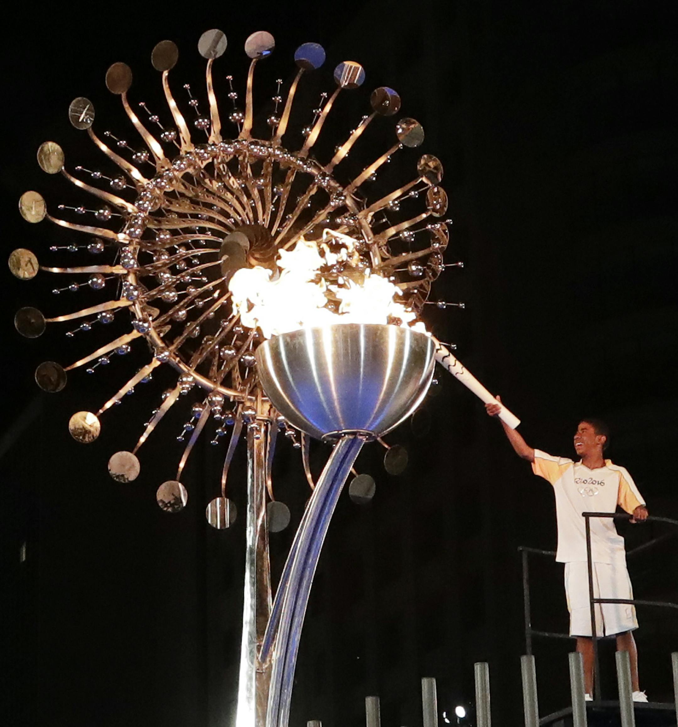 Jorge Alberto Oliveira Gomes lights the Olympic cauldron during the opening ceremony of the 2016 Summer Olympics in Rio de Janeiro, Brazil, Saturday, Aug. 6, 2016. (AP Photo/Gregory Bull)