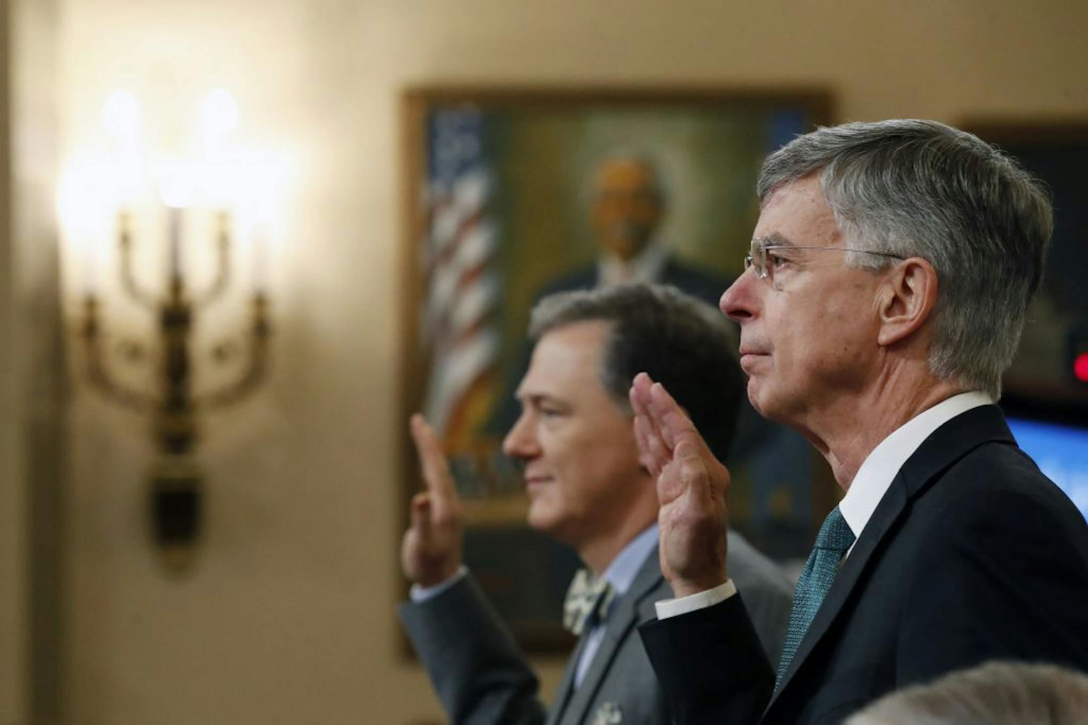 Top U.S. diplomat in Ukraine William Taylor, right, and career Foreign Service officer George Kent, left are sworn in to testify before the House Intelligence Committee on Capitol Hill in Washington, Wednesday, Nov. 13, 2019, during the first public impeachment hearing of President Donald Trump's efforts to tie U.S. aid for Ukraine to investigations of his political opponents.