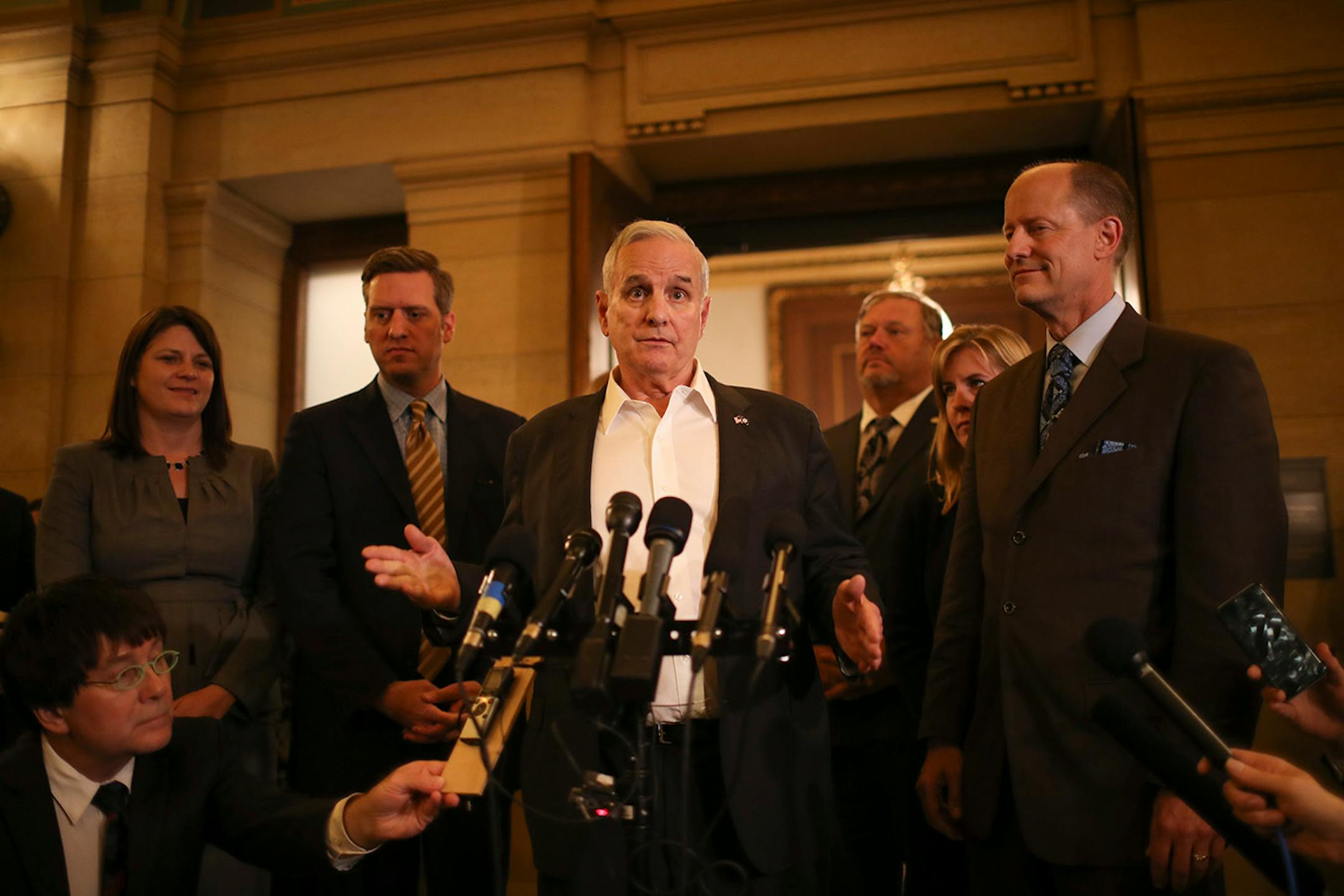 Governor Mark Dayton addressed reporters after it was announced that an agreement had been reached to convene a special session at 12:01 a.m. Tuesday to take on the outstanding budget bills and the tax bill. With Dayton were, from left, Rep. Joyce Peppin, House Majority Leader, Rep. Kurt Daudt, Speaker of the House, Senator Tom Bakk, Senate Minority Leader, Rep. Melissa Hortman, House Minority Leader, and Senator Paul Gazelka, Senate Majority Leader.
