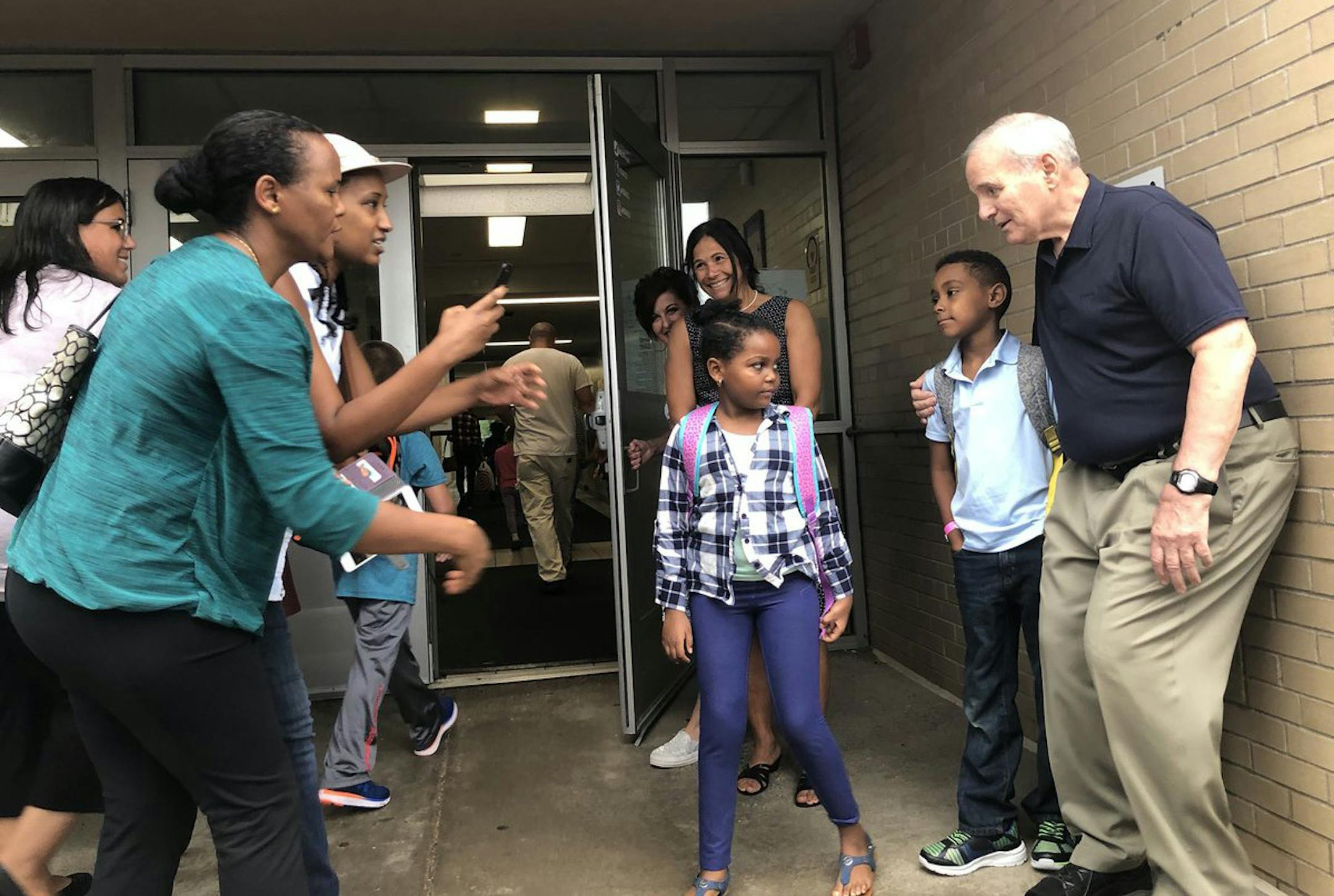 Gov. Mark Dayton poses for photos with students at Carver Elementary in Maplewood.