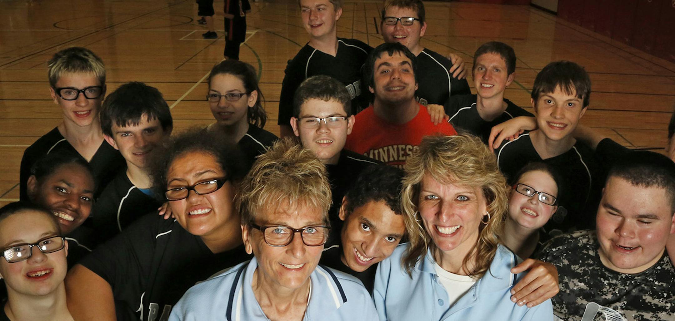 Long-time adapted sports officials Jacki Wincek and Michelle Schneider are surrounded by current and former players in between games. ] (KYNDELL HARKNESS/STAR TRIBUNE) kyndell.harkness@startribune.com During the adapted softball state championship in Coon Rapids Min., Thursday, May 28, 2015. ORG XMIT: MIN1505292050590006