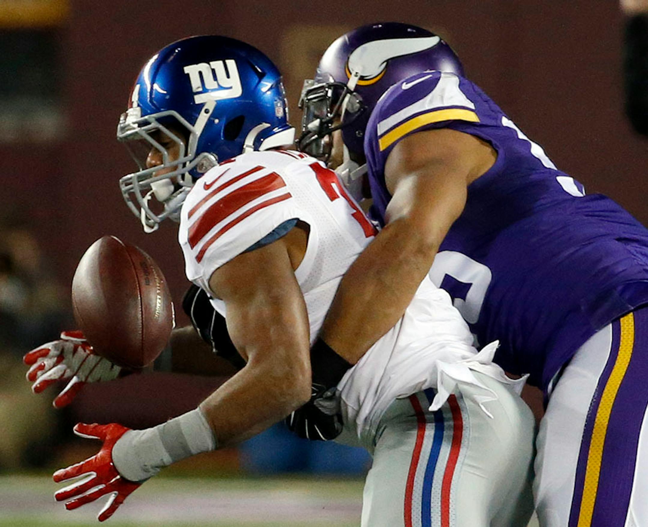 New York Giants running back Shane Vereen (34) is unable to catch a pass as he is hit by Minnesota Vikings outside linebacker Anthony Barr, right, during the second half of an NFL football game Sunday, Dec. 27, 2015, in Minneapolis.