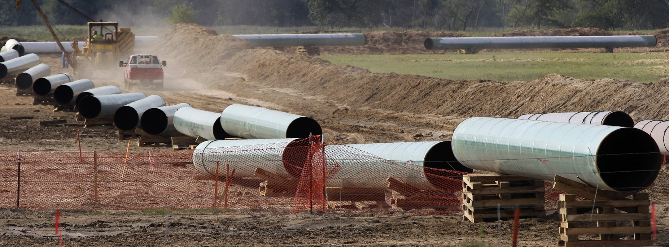 File - In the is Oct. 4, 2012 file photo, large sections of pipe are shown on a neighboring property to Julia Trigg Crawford family farm, in Sumner Texas. On Wednesday, Jan 22, 2014, TransCanada said in a statement on its website that it is delivering oil through the Gulf Coast portion of its proposed Keystone XL pipeline, from a hub in Cushing, Okla., to Houston-area refineries. (AP Photo/Tony Gutierrez, file) ORG XMIT: MIN2014021315213704