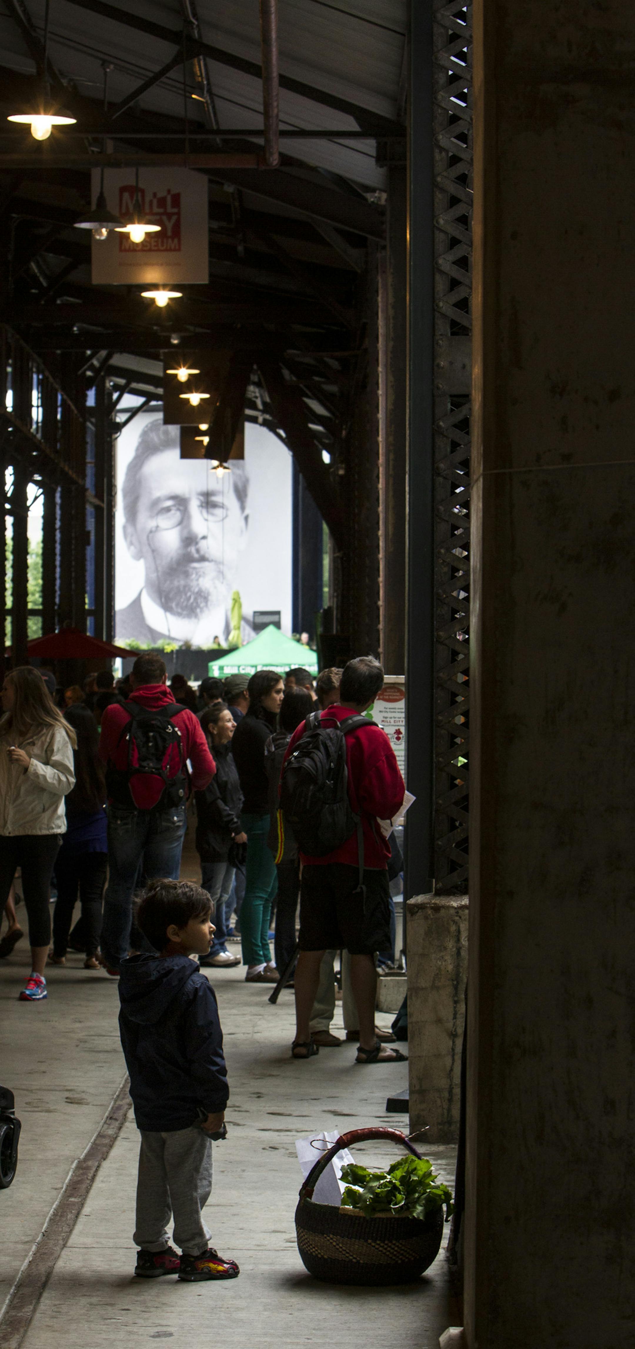 Aidan Daftari, 3, of Maple Grove waits for his mother by their basket of produce at Mill City Farmers Market in Minneapolis June 14, 2014. (Courtney Perry/Special to the Star Tribune)