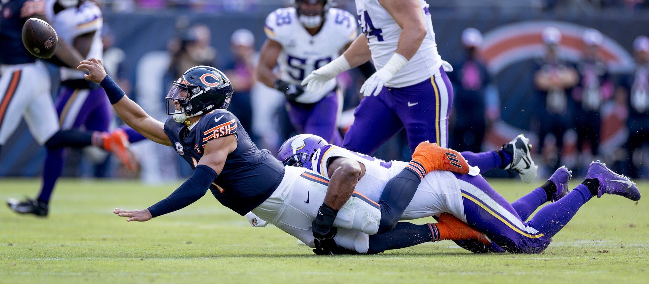 Chicago Bears quarterback Justin Fields (1) is sacked by Danielle Hunter (99) of the Minnesota Vikings in the third quarter.