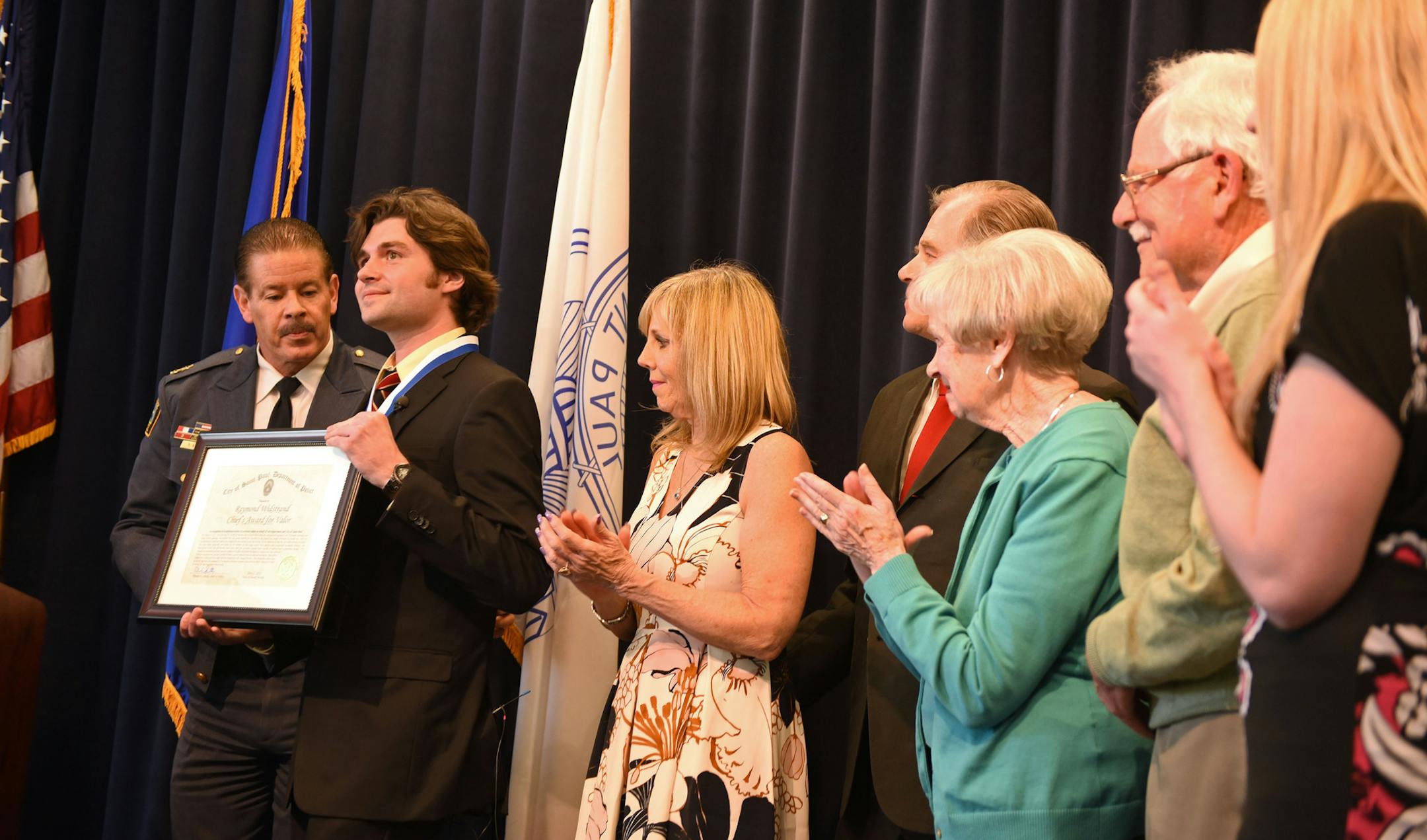 Ray Widstrand receives the chief's award for valor at the Saint Paul Police Western District building in Saint Paul on Friday, April 22, 2016.. Mr. Widstrand was nearly beaten to death in 2013 when he tried to help a woman who had fallen during a street brawl. Tanikqwa Givens, who threw herself over Ray Widstrand's body during the attack, was also honored. ] MARK KEGANS, Special to the Star-Tribune, Saint Paul, MN, April 22, 2016