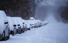 Snow-covered vehicles stacked up during the third consecutive day of snowfall on Feb. 23, 2023 in Minneapolis. DAVID JOLES • david.joles@startrib