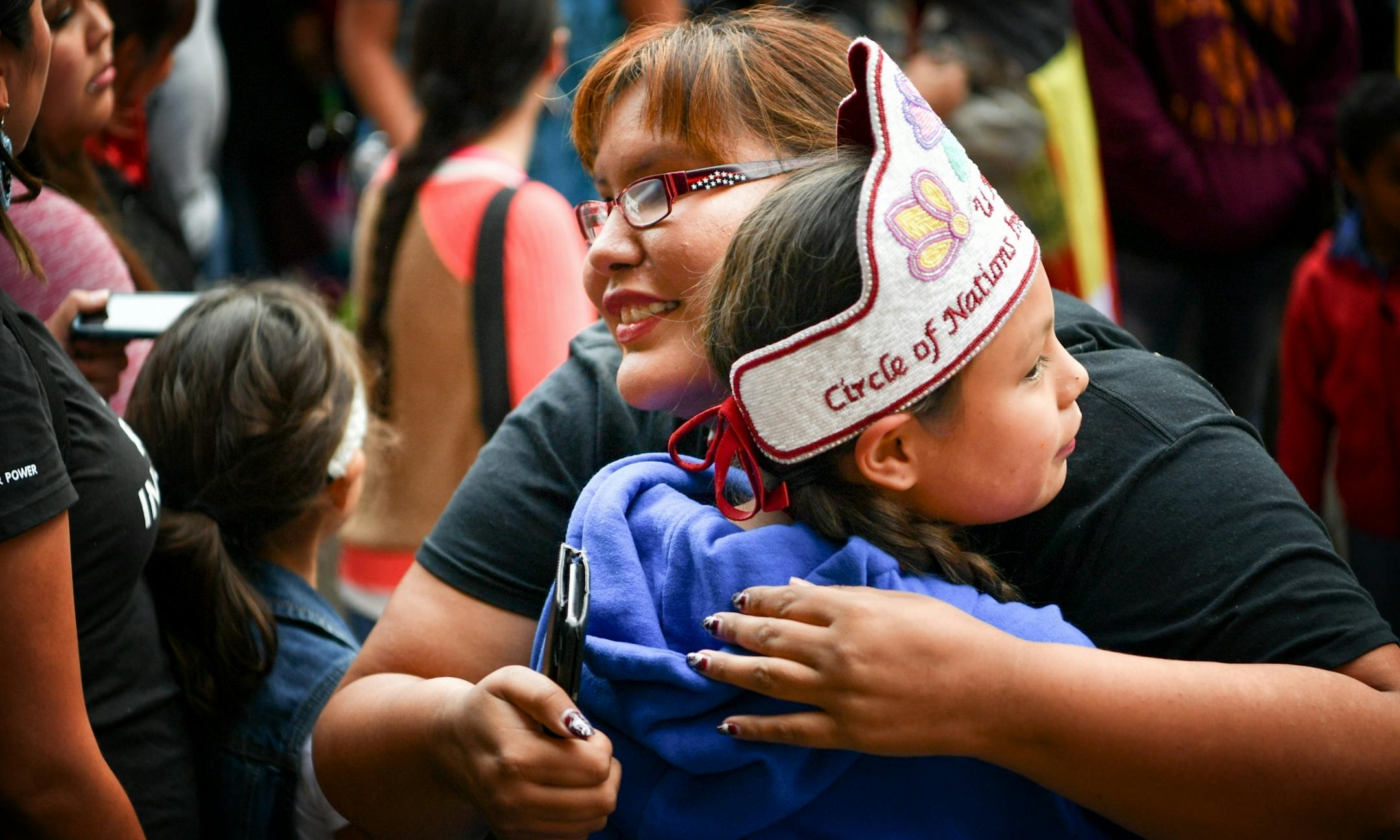Activist Crystal Norcross hugged Tracy Menard just before she sang a song during the protest. Protesters outside Minneapolis City Hall were angered that Hennepin County Sheriff deputies were participating in Standing Rock where Native People are fighting the pipeline.