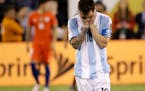 Argentina's Lionel Messi reacted after missing his shot during penalty kicks in the Copa America Centenario championship soccer match, Sunday, June 26