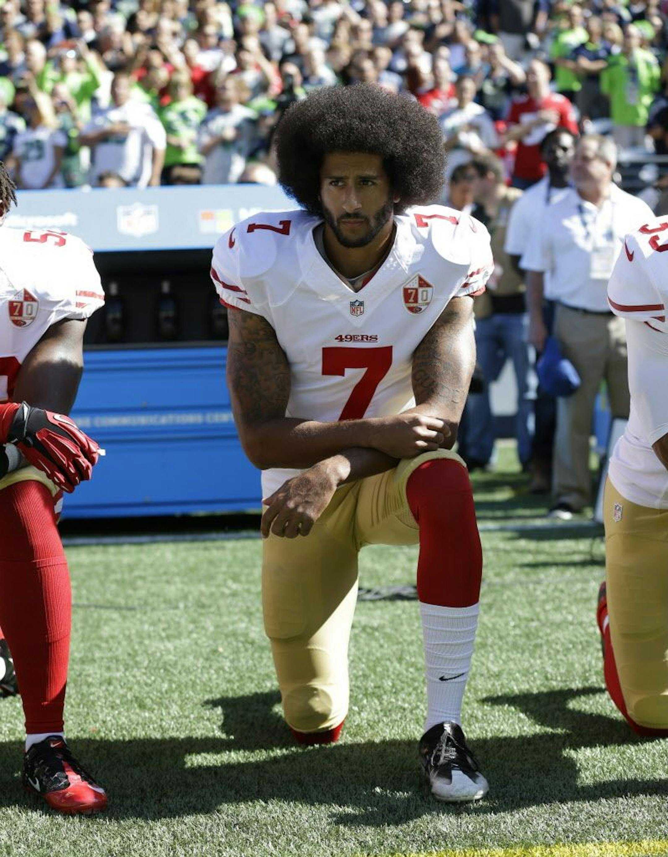 FILE - In this Sept. 25, 2016, file photo, San Francisco 49ers' Colin Kaepernick kneels during the national anthem before an NFL football game against the Seattle Seahawks, in Seattle. Kaepernick has a new deal with Nike, even though the NFL does not want him. Kaepernick's attorney, Mark Geragos, made the announcement on Twitter, calling the former 49ers quarterback an "All American Icon" and crediting attorney Ben Meiselas for getting the deal done.