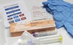 FILE - This May 13, 2015, file photo shows the contents of a drug overdose rescue kit at a training session on how to administer naloxone, which rever