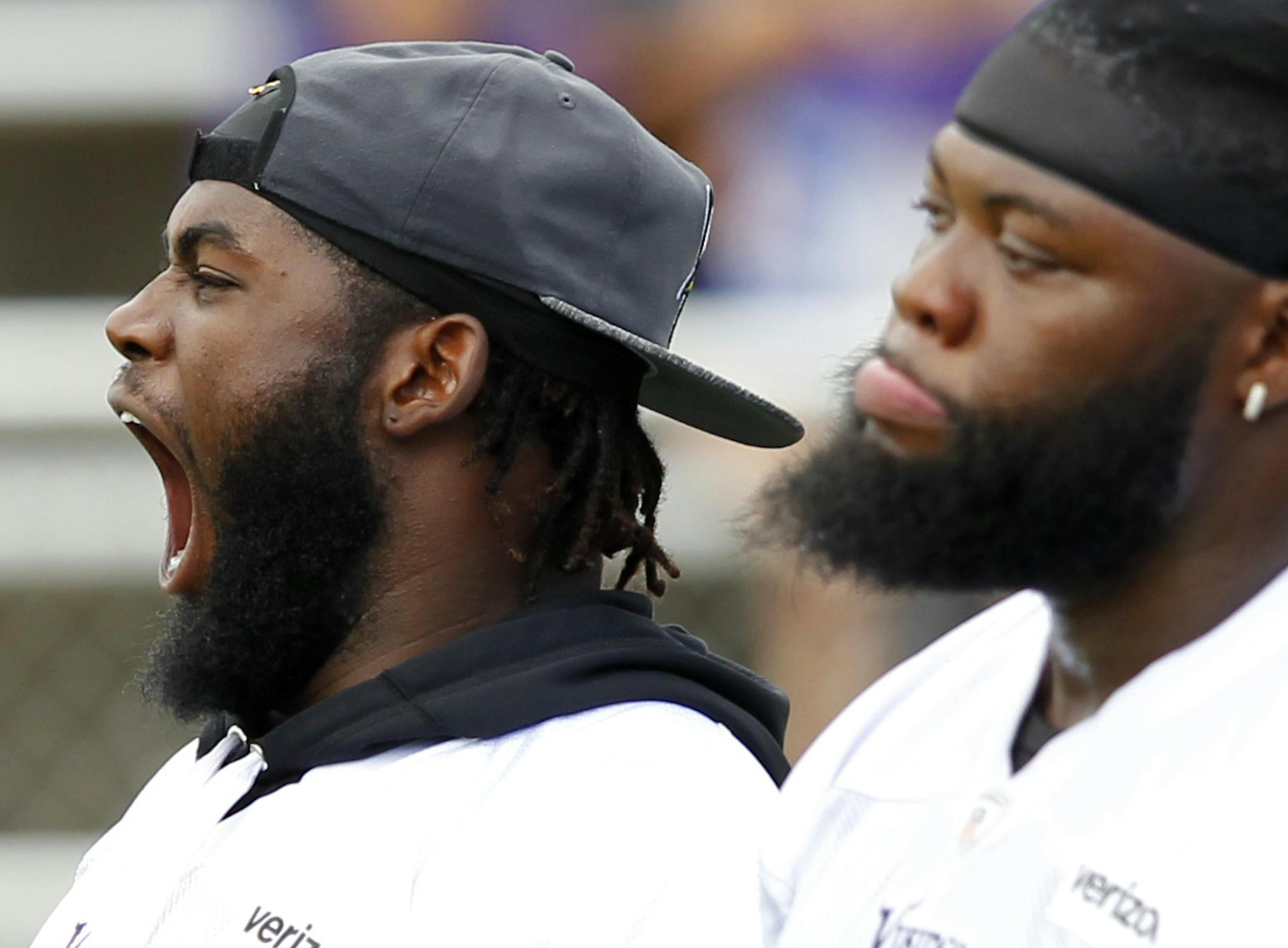 Minnesota Vikings defensive tackle Sharrif Floyd (73) yawns and defensive tackle Linval Joseph (98) watch walk throughs during the first day of NFL football training camp at Mankato State University in Mankato, Minn. on Friday, July, 29, 2016.(AP Photo/Andy Clayton-King)