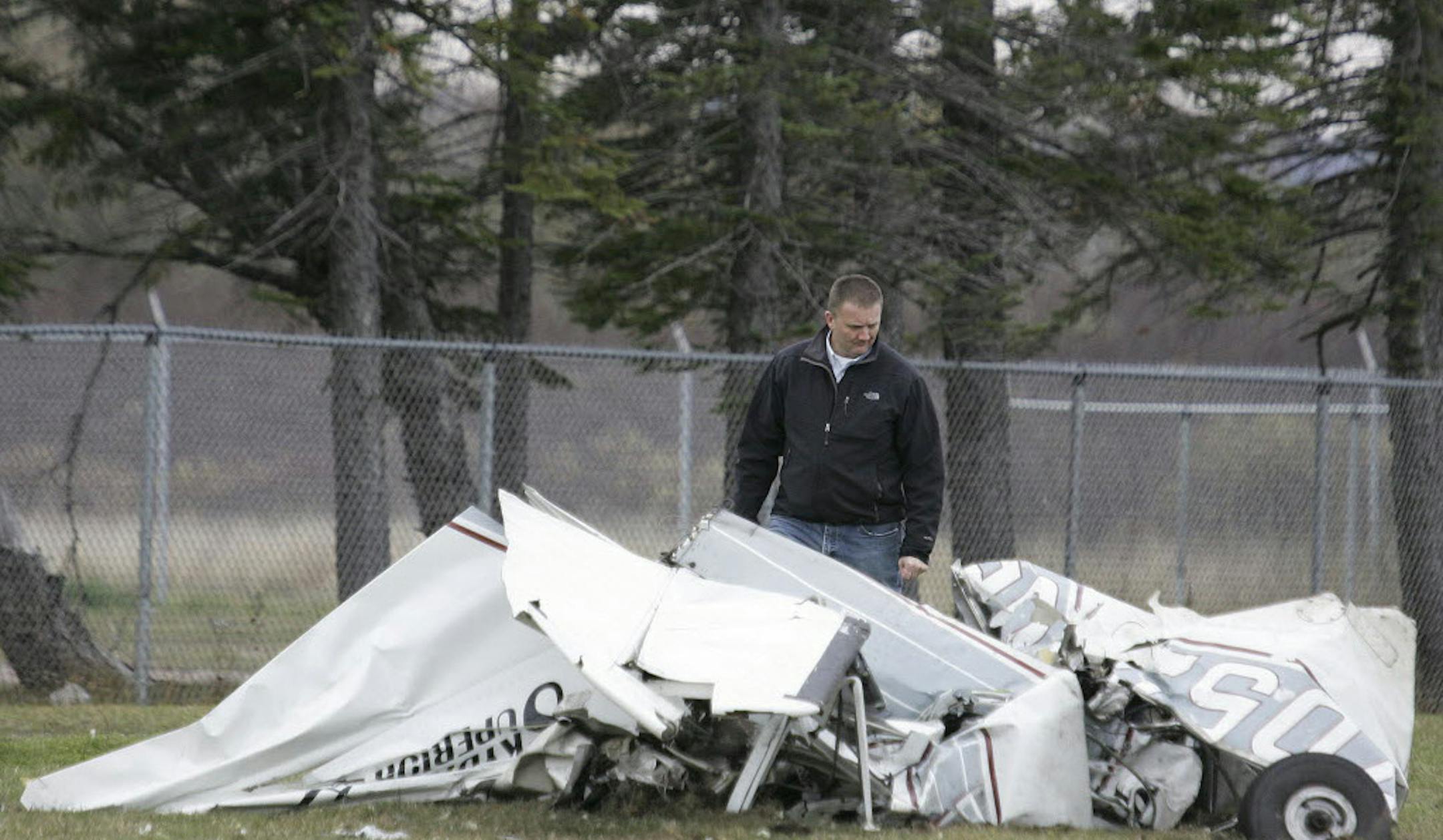 An FAA investigator examined the wreckage of a Cessna Sunday in Superior, Wis., a day after its pilot survived a midair collision with another plane. Both planes were carrying sky divers.