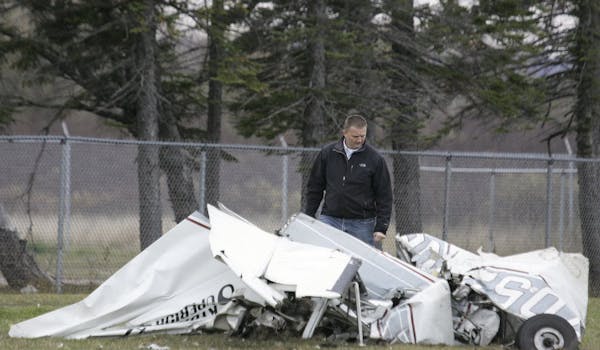 An FAA investigator examined the wreckage of a Cessna Sunday in Superior, Wis., a day after its pilot survived a midair collision with another plane. 
