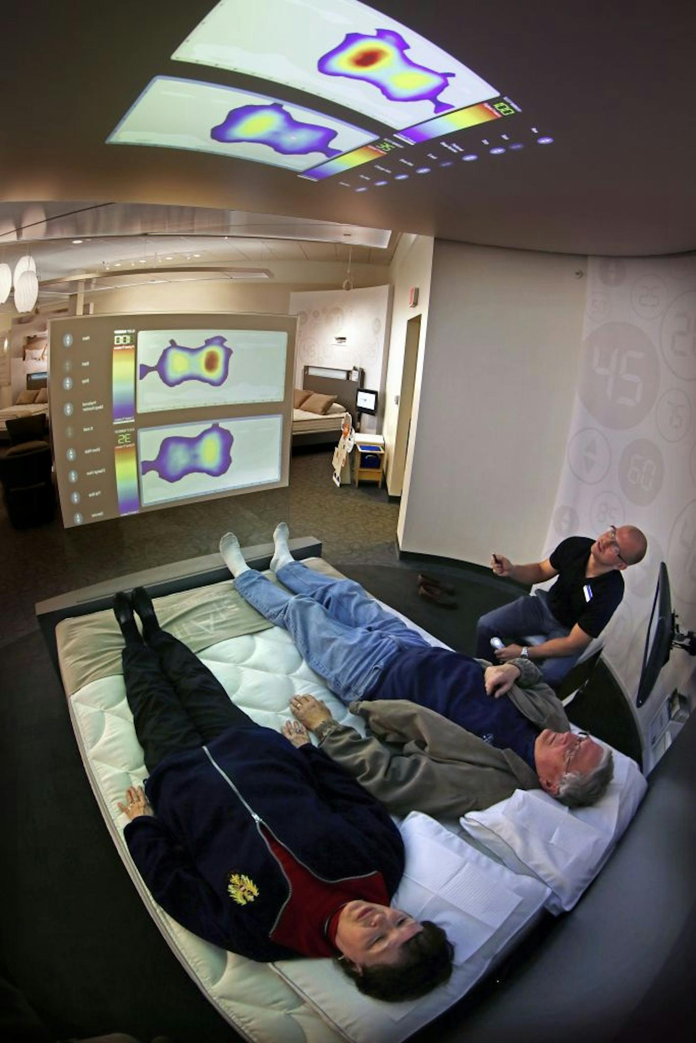 Two customers found their sleep number with the help of a computer-projected pressure graph with manager Dan Patton at Select Comfort's Sleep Number store on France Avenue in Edina.