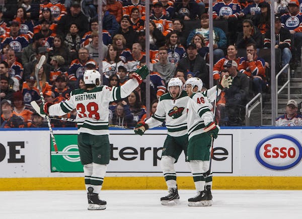 Minnesota's Ryan Hartman (38), Marcus Foligno (17) and Jared Spurgeon (46) celebrate a goal against the Oilers during the second period.